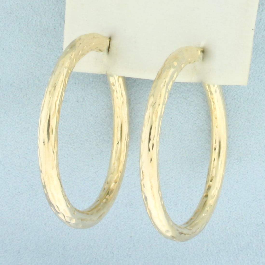 Daimond Cut Hoop Earrings in 14k Yellow Gold: In 14k Yellow Gold. 1.5 inch diameter. 4mm wide. Diamond cut to give unique sparkle texture. Leverback. 3.5g.