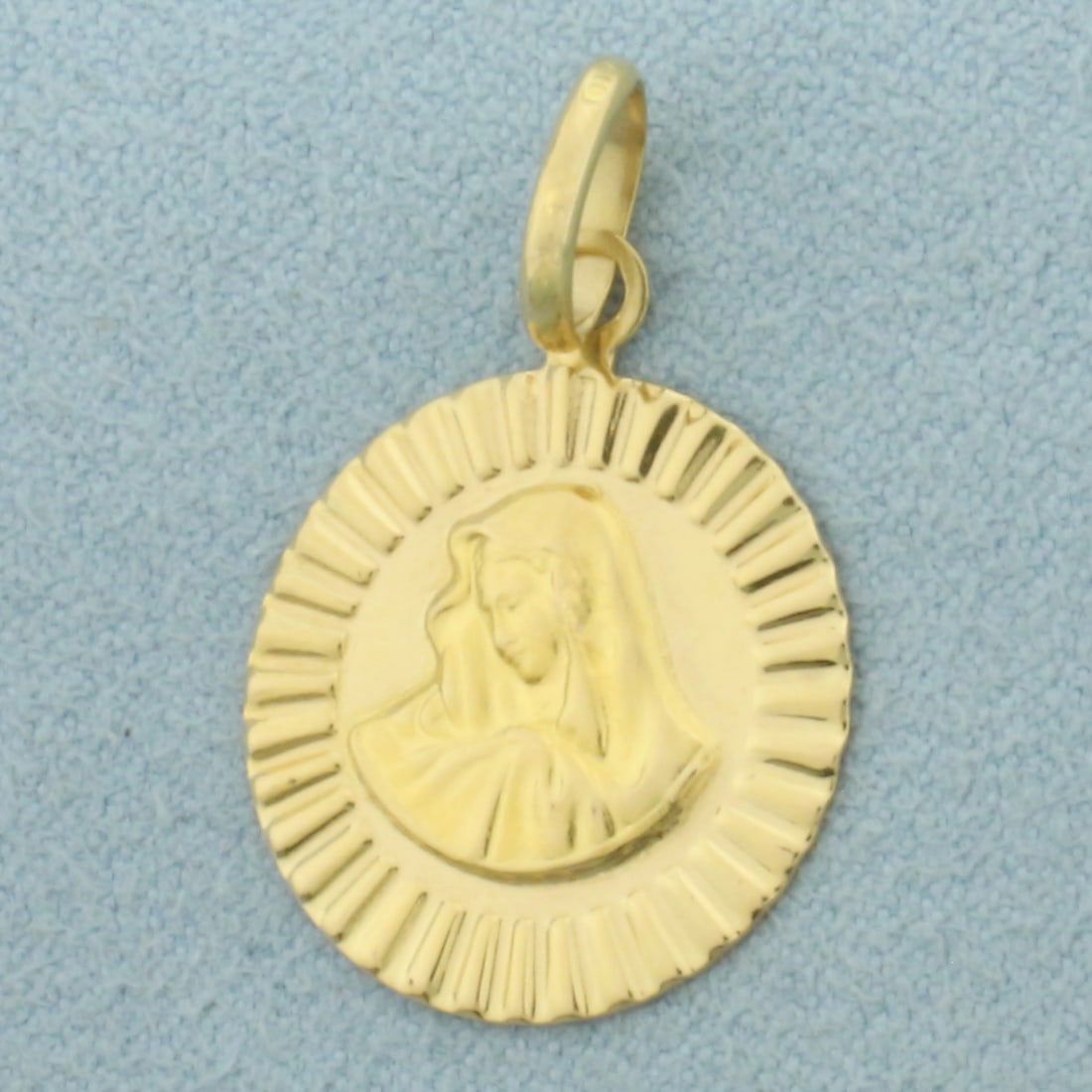 Madonna Virgin Mary Medallion Pendant or Charm in 18k Yellow Gold: In 18k Yellow Gold. 1 inch long (including bale). 3/4 inch wide. 2.0g.