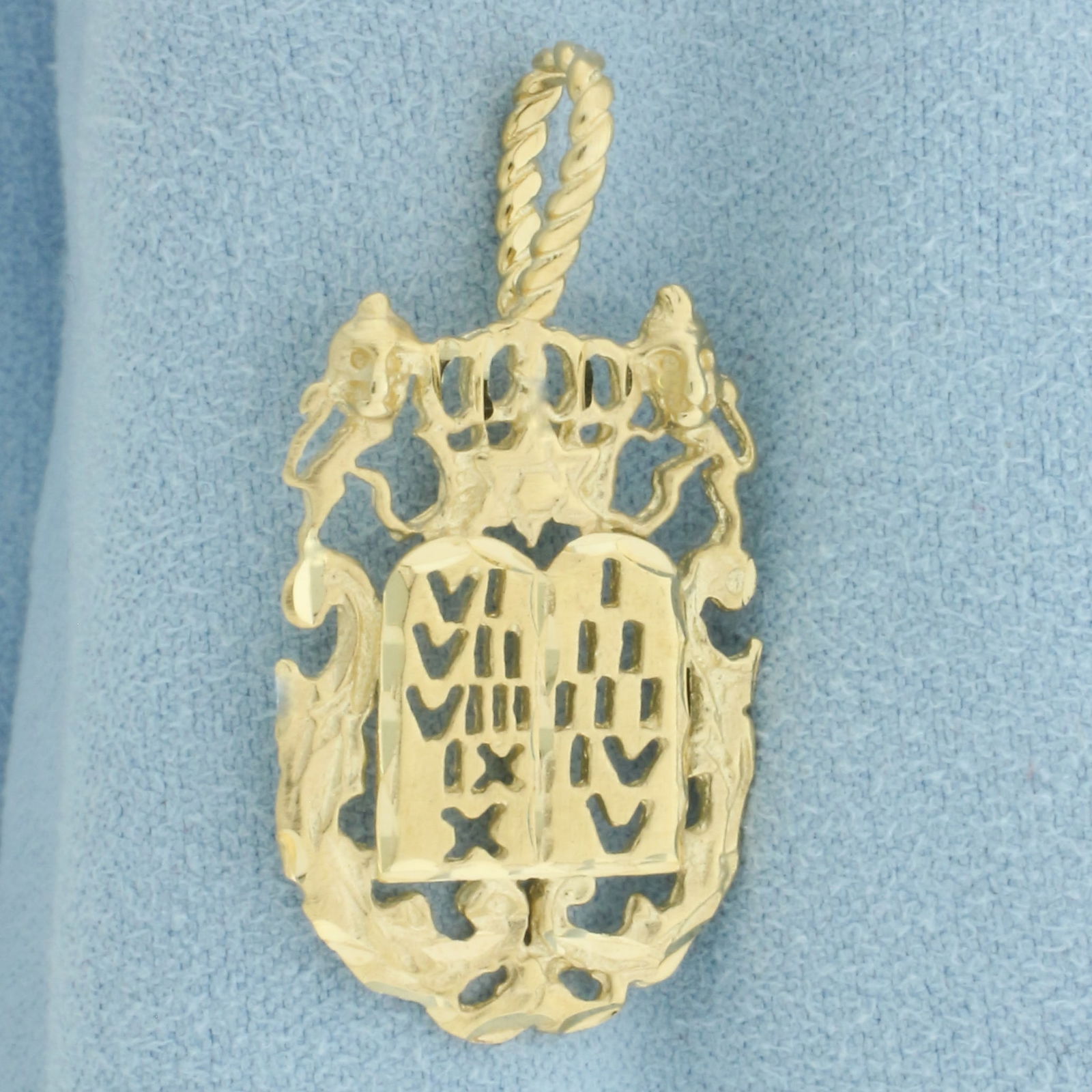 Ten Commandments Tablets Pendant in 14k Yellow Gold: In 14k yellow gold. Measures 1 3/8 inch long x 3/4 inch wide. Diamond cut. 3.2g.