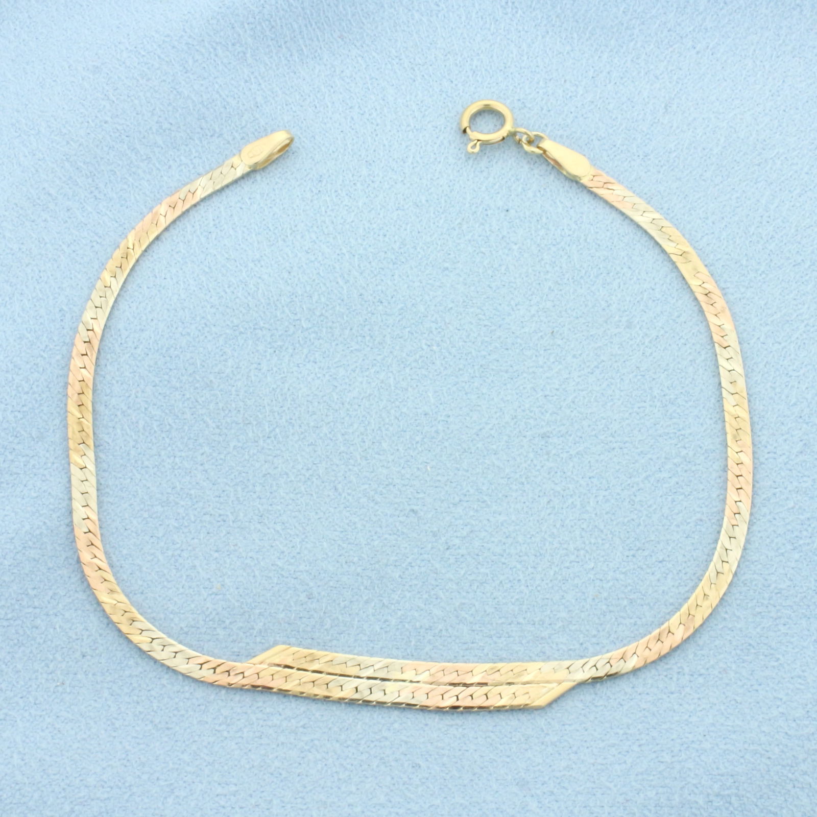 Italian Tri-Color Herringbone Link Bracelet in 14k Yellow, Rose, and White Gold: In 14k Yellow, Rose, and White Gold. 7 inches long. 4.5mm wide (at widest). Made in Italy. Spring clasp. 2.8g.