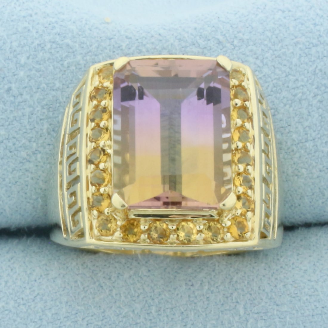 Ametrine and Citrine Greek Key Ring in 10k Yellow Gold: In 10k Yellow Gold. Contains one 14x10mm emerald cut natural Ametrine gemstone, approximately 6cts, with bright color and excellent clarity. Also contains twenty-six 2mm high quality natural Citrine g