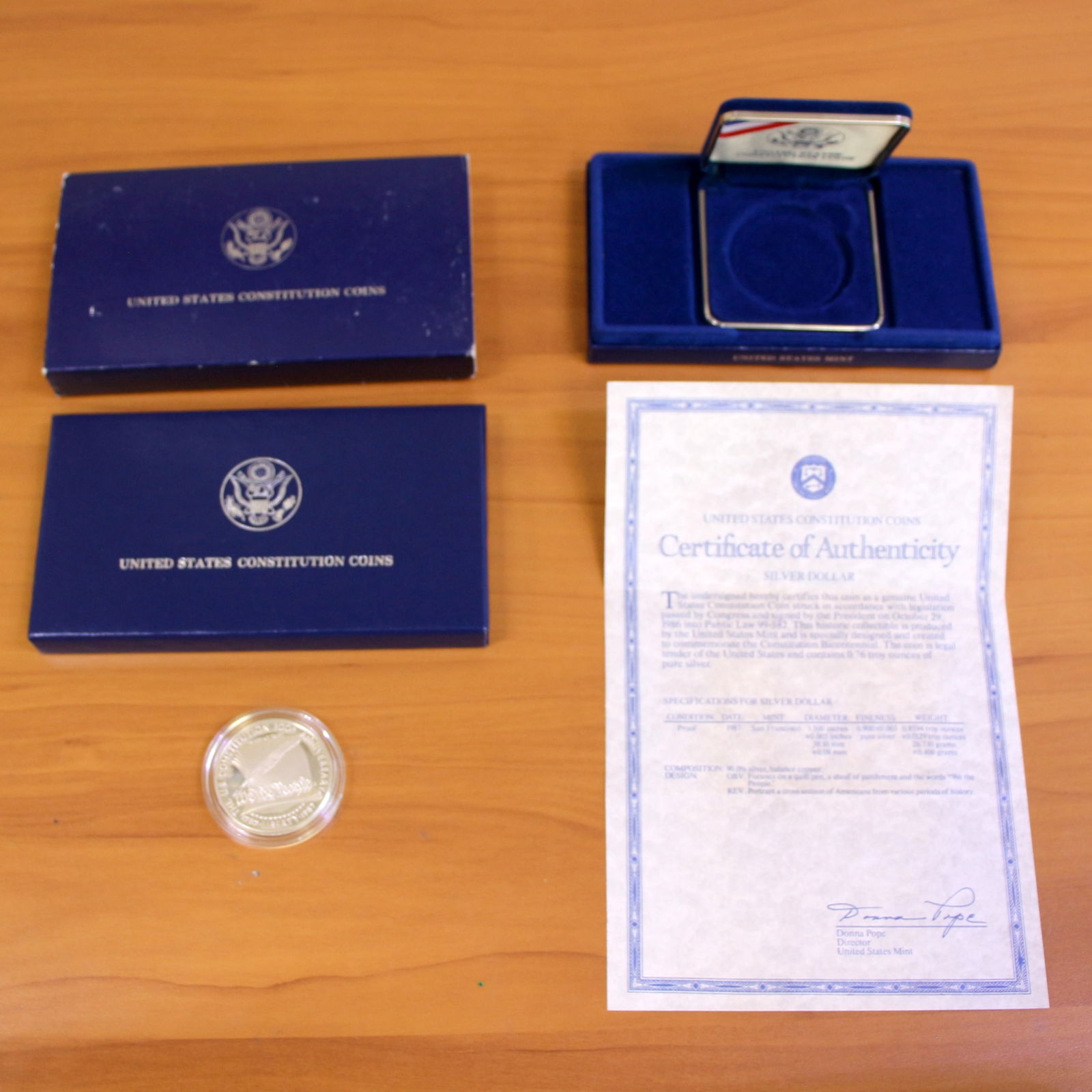 US Mint Constitution Silver Dollar OGP: Contains one 1987 United States Mint Constitution Silver Dollar. Set in original packaging and contains certificate of authenticity.