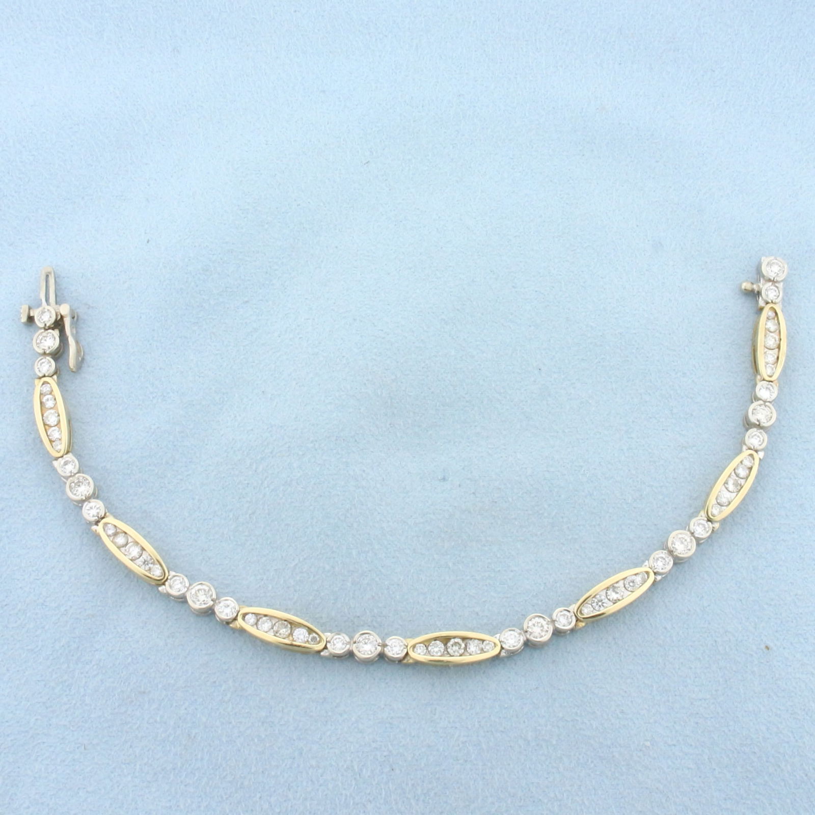 Two Tone Diamond Tennis Bracelet in 14K Yellow and White Gold: In 14K Yellow and White Gold. Contains 58 high quality diamonds ranging from .02ct to .12ct each, 3ct TW, VS clarity/H color. 7 inches long. 4.6mm wide. 13.6g.