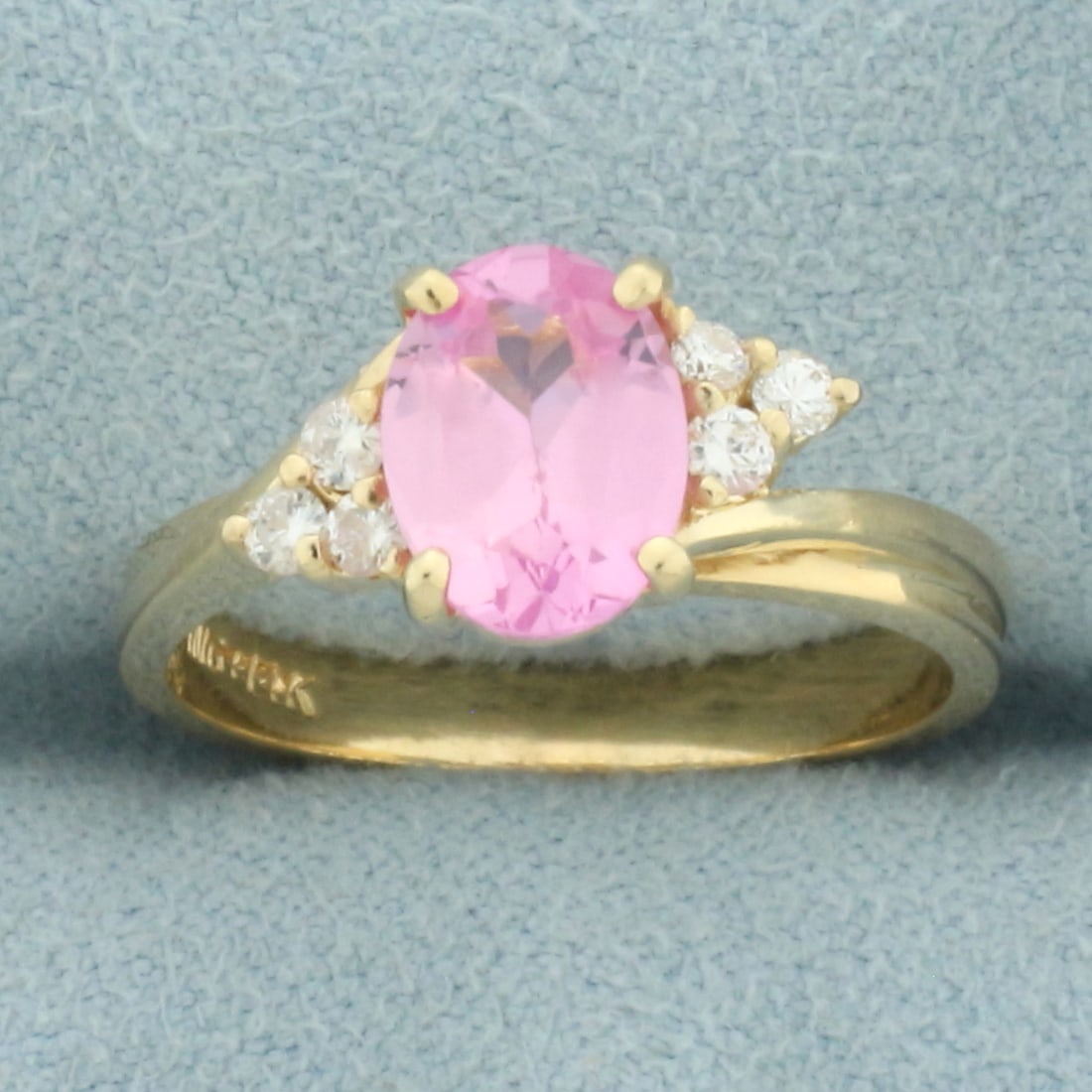 Pink Topaz and Diamond Ring in 14k Yellow Gold: In 14k yellow gold. Contains one high quality 1.5ct Pink Sapphire gemstone with vibrant color and excellent clarity. Also contains six high quality .03ct diamonds, G color/SI clarity. Size: 6. 3.3g.
