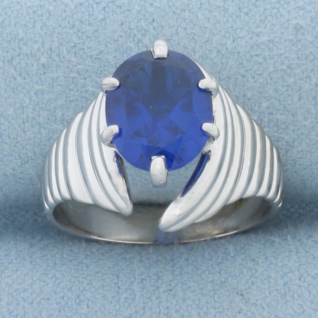 3ct Lab Sapphire Scalloped Design Ring in 14k White Gold: In 14k white gold. Contains one high quality 10mm by 8mm Lab Sapphire gemstone, approximately 3cts, with vibrant color and excellent clarity. Size: 6.25. 7.2g.