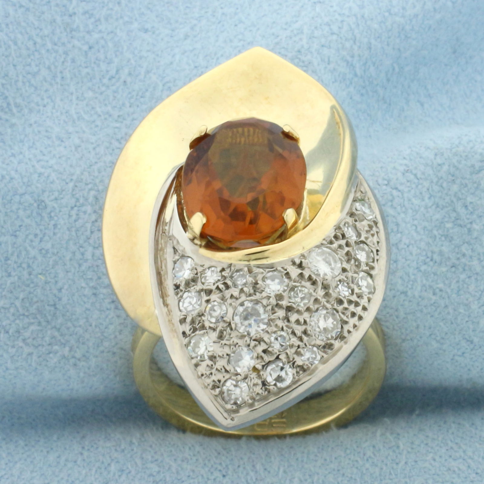 Citrine and Diamond Statement Ring in 18k Yellow Gold: In 18k Yellow Gold. Contains one high quality natural 12mmx9mm Citrine gemstone, approximately 3cts, with intense reddish orange color and excellent clarity. Also contains 21 high quality diamonds, 3/