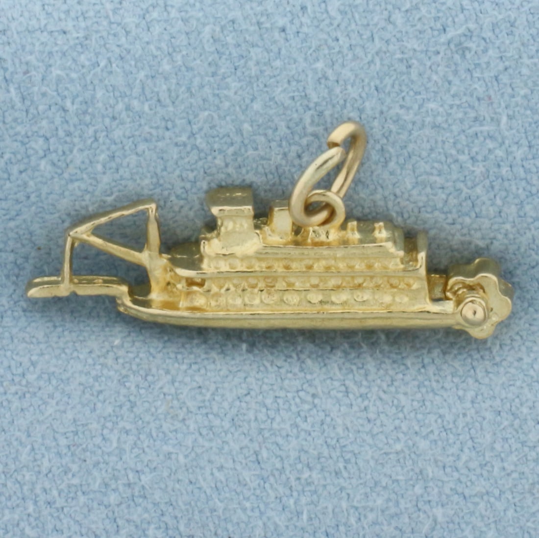 Delta Queen Mechanical Paddle Boat Charm in 14k Yellow Gold: In 14k Yellow Gold. 3/8 inch tall including jump ring. 1 inch wide. 3-D design. Paddlewheel moves. 3.5g.