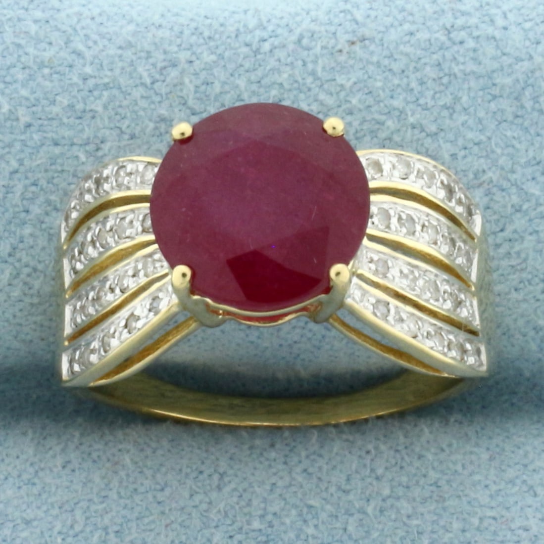 Ruby and Diamond Ring in 14k Yellow Gold: In 14k Yellow Gold. Contains one high quality 10mm, approximately 4ct, natural Ruby gemstone with intense color. Also contains forty 1/2pt high quality diamonds. Size 8. 4.6g.