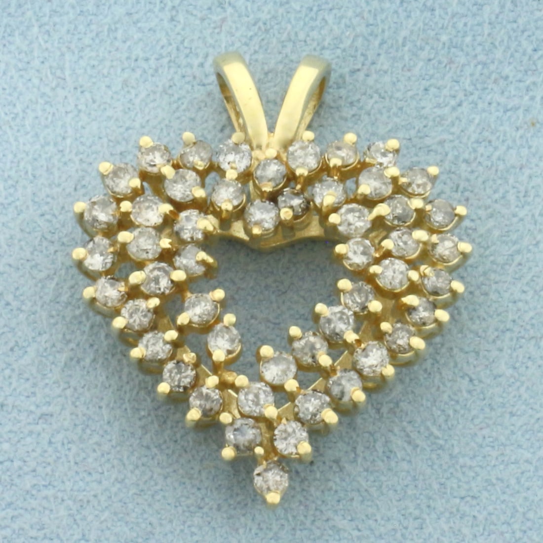 Large Diamond Heart Pendant in 14k Yellow Gold: In 14k Yellow Gold. Contains fifty high quality diamonds, 1.5ct TW, I color/I clarity. 1 1/8 inch long. 1 inch wide. 5.6g.