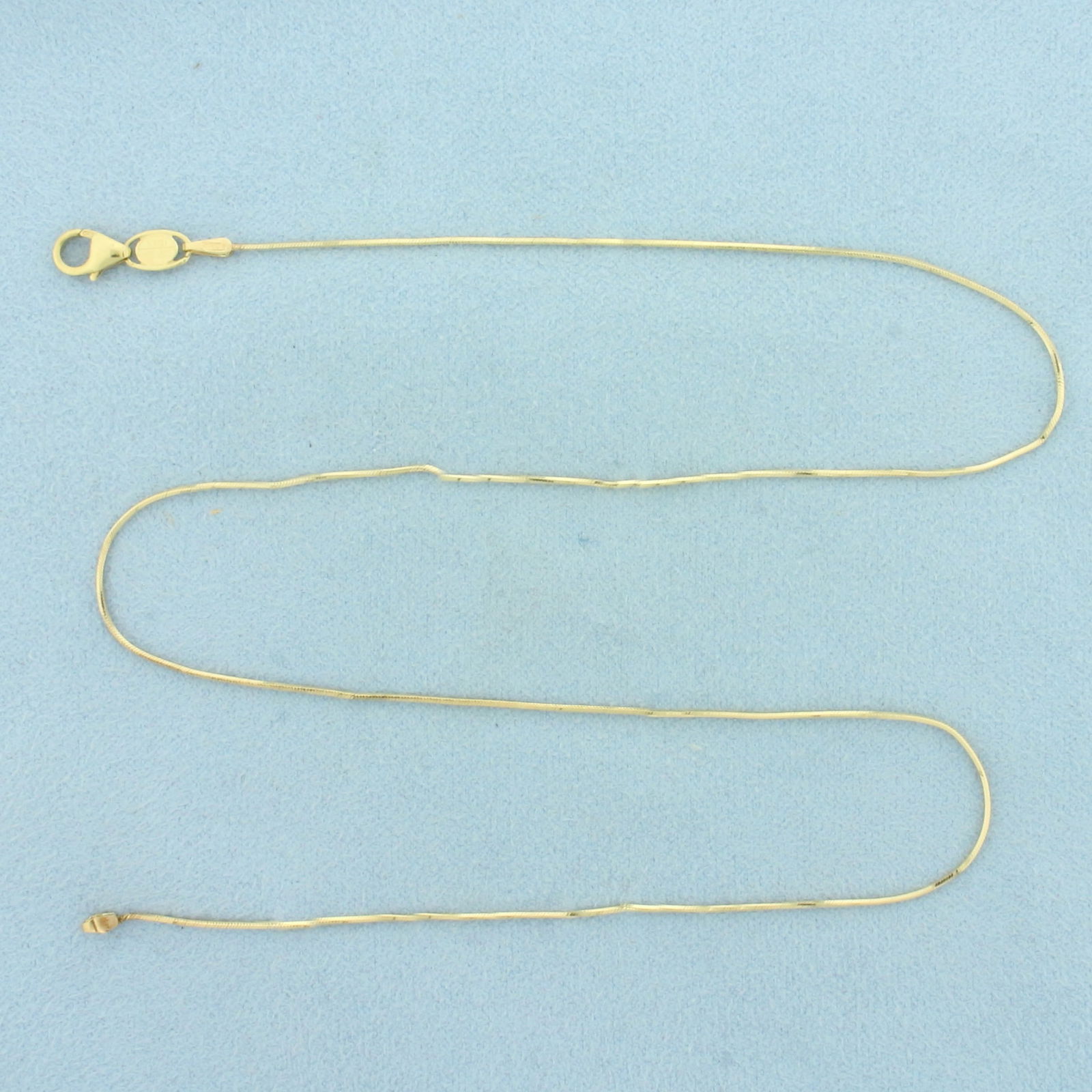 Italian 16 Inch Snake Link Chain Choker Necklace in 14k Yellow Gold: In 14k Yellow Gold. 16 inches long. 0.7mm wide. Italian made. Lobster clasp. 2.5g.