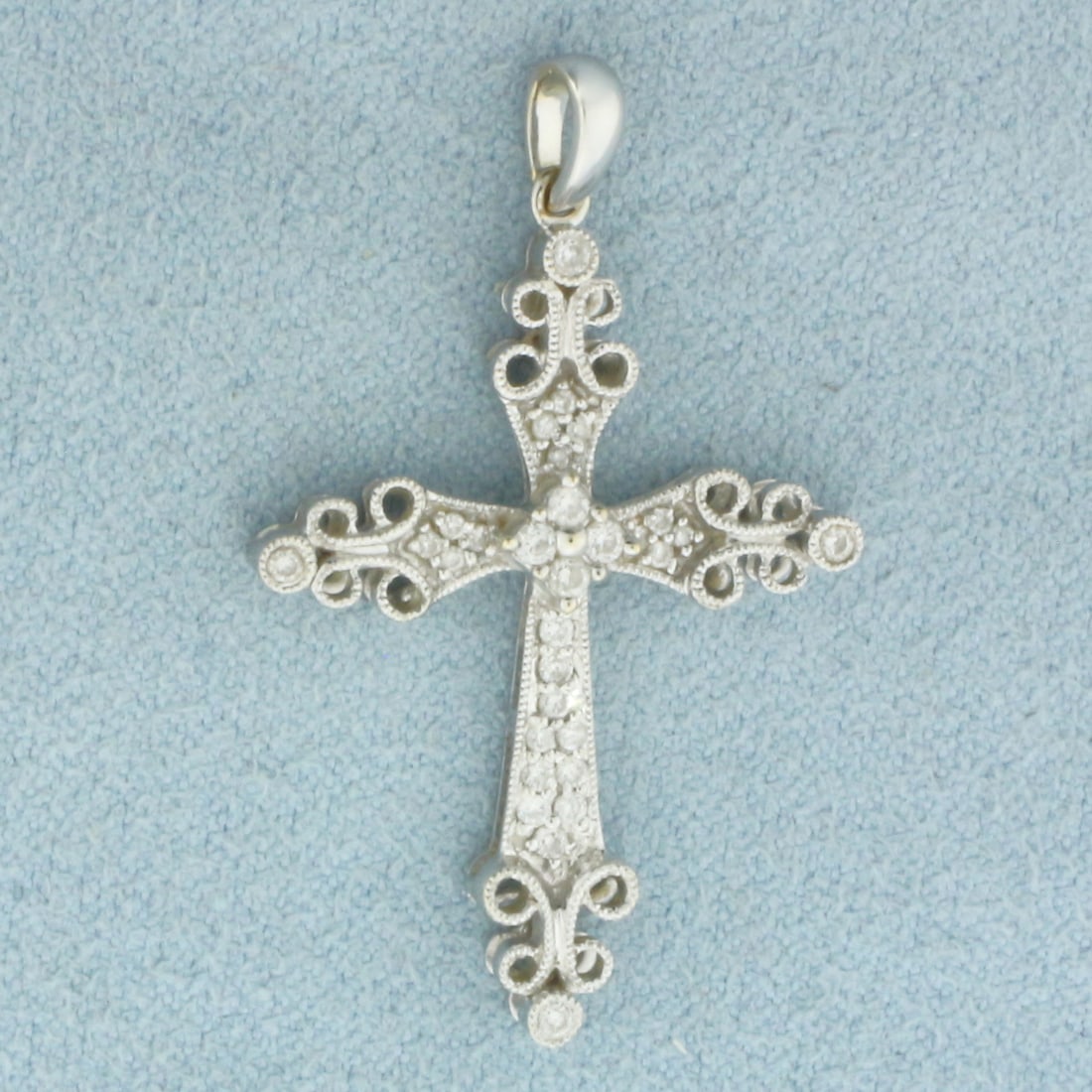 Diamond Cross Pendant in 18k White Gold: In 18k White Gold. Contains 30 high quality diamonds, 1/4ct TW, SI clarity/G color. 1 3/8 inch long. 7/8 inch wide. 2.8g.