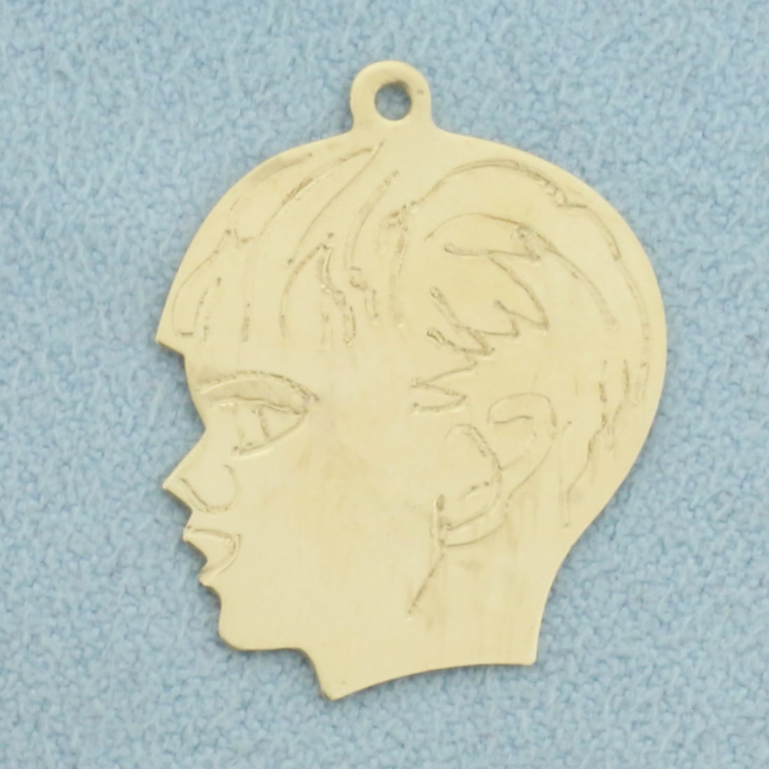 Engravable Boy Silhouette Charm in 14k Yellow Gold: In 14k Yellow Gold. 1 inch long. 3/4 inch wide. Can engrave name or date on back. 1.4g.