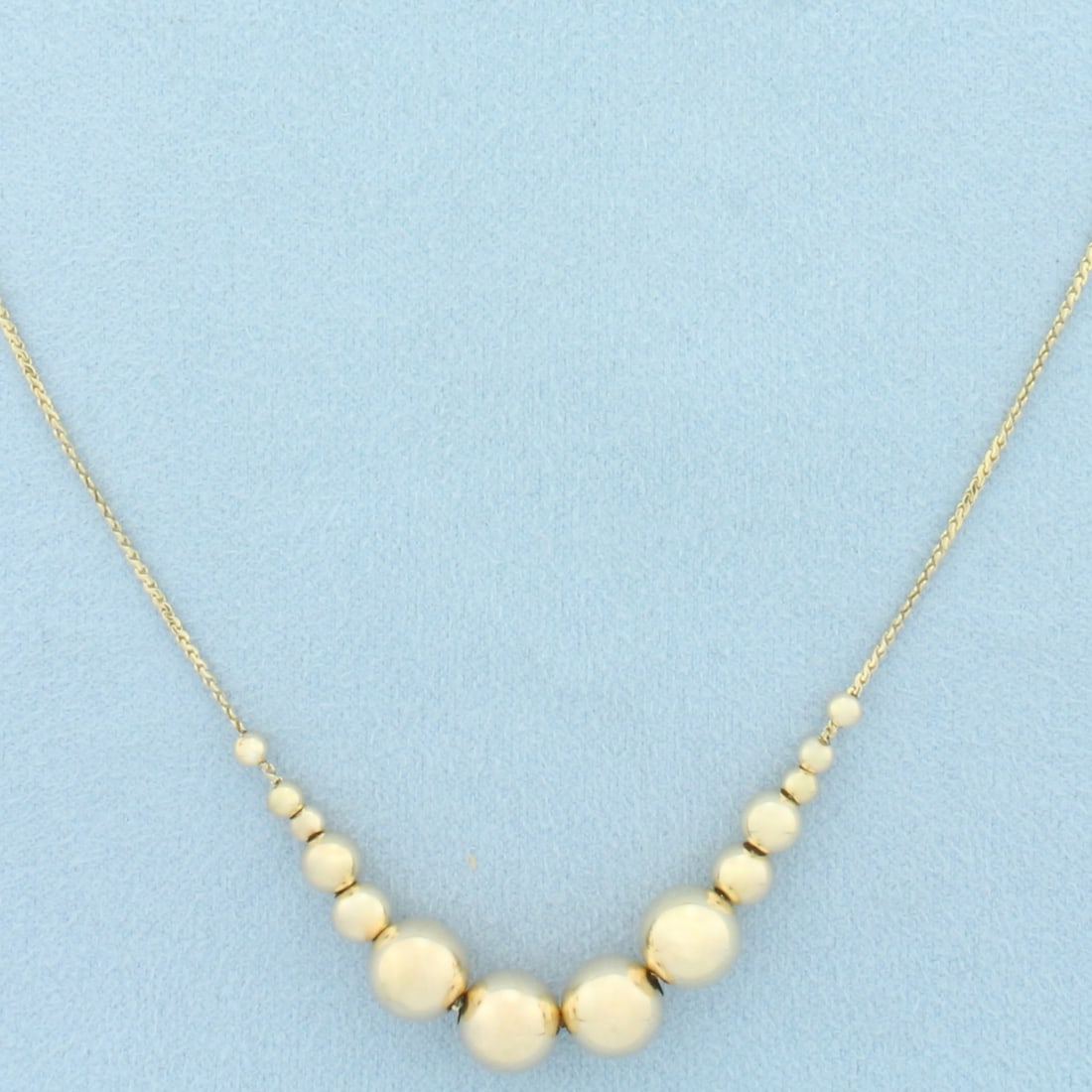 Graduated Ball Bead Necklace in 14k Yellow Gold: In 14k Yellow Gold. Contains 3-8mm high quality gold ball beads. 17 inches long. 1mm wide S-link chain. 4.7g.