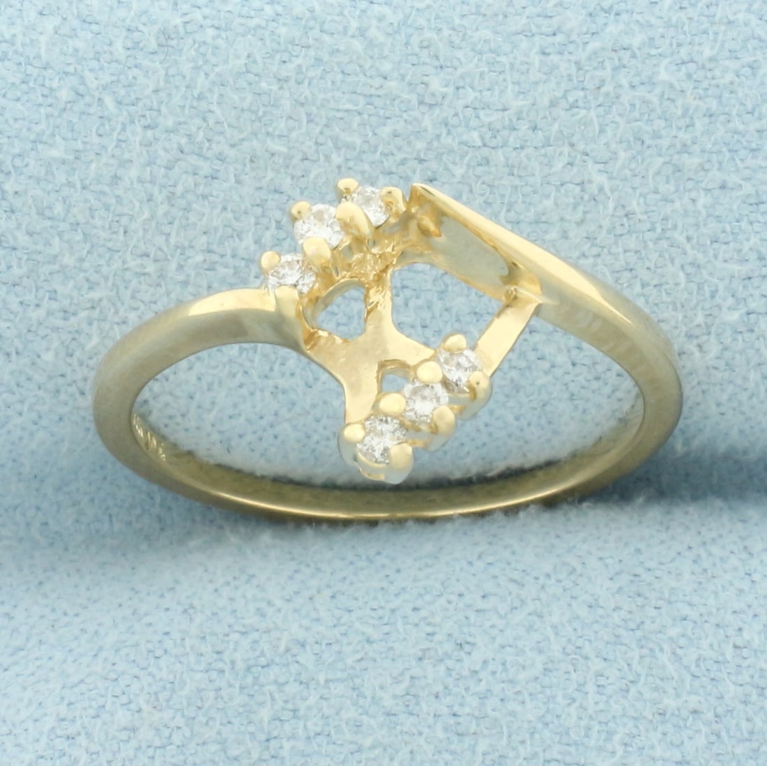 Diamond Ring Enhancer Jacket in 14k Yellow Gold: In 14k Yellow Gold. Contains six high quality .01ct diamonds, SI clarity/H color. 10mm wide at top. Meant to fit around solitaire diamond engagement ring to give new look. Size 7. 2.1g.