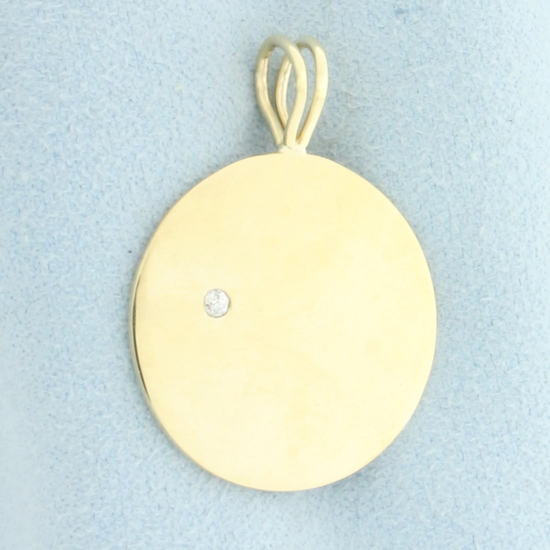 Diamond Engravable Medallion Disc Pendant in 14k Yellow Gold: In 14k Yellow Gold. Contains one high quality .03ct diamond, SI clarity/H color. 1 1/4 inch long including bale. 7/8 inch wide. Engravable on either side. 6.0g.