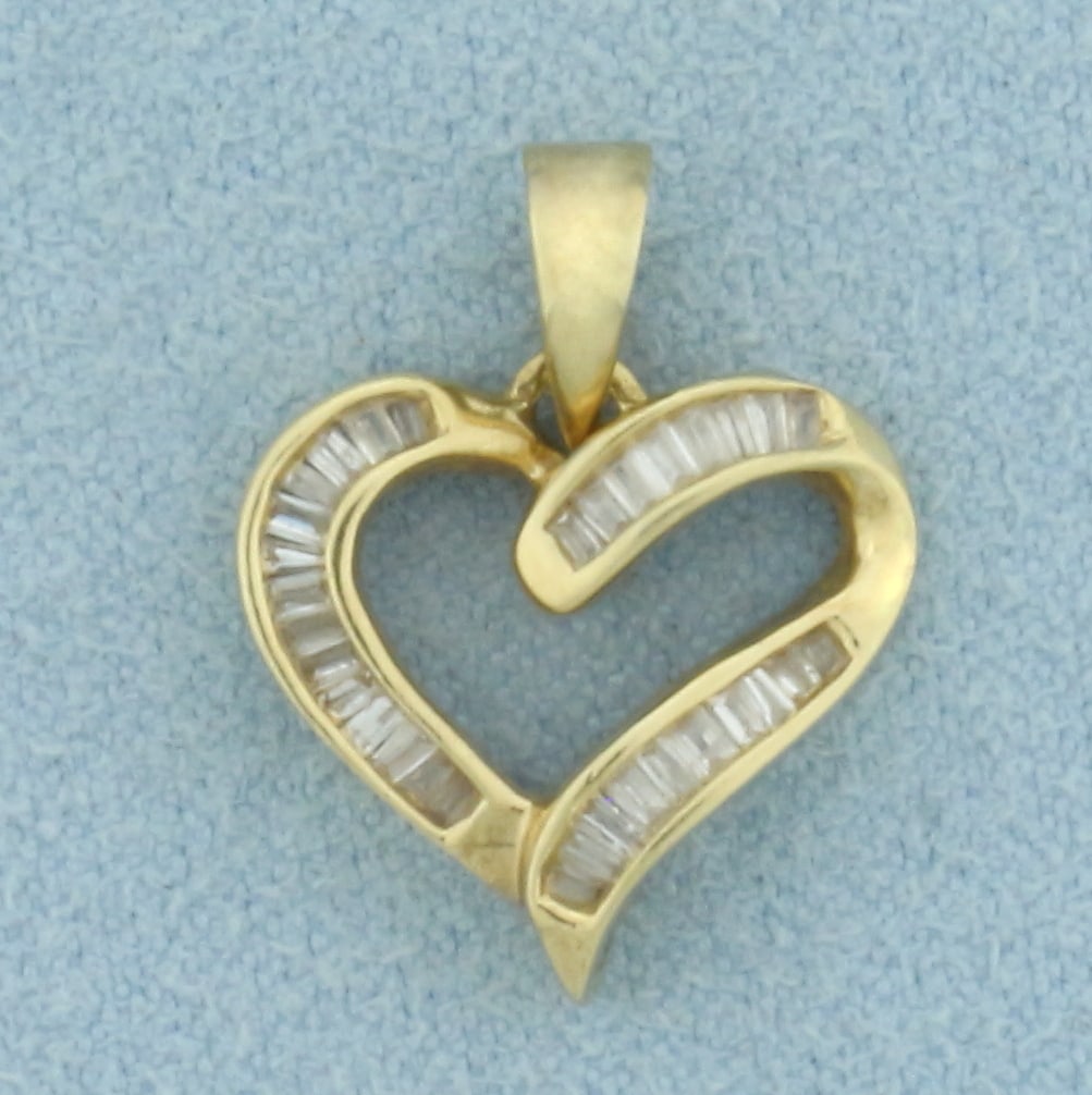 Baguette Diamond Heart Pendant in 14k Yellow Gold: In 14k Yellow Gold. Contains 31 high quality baguette diamonds, 1/4ct TW, SI clarity/H color. 3/4 inch long. 5/8 inch wide. 2.0g.