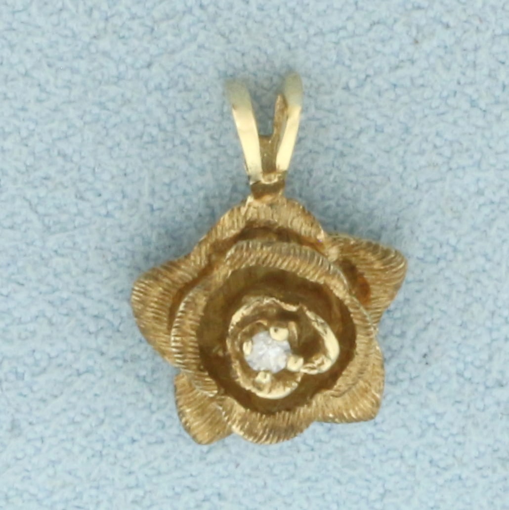 Diamond Rose Flower Pendant in 14k Yellow Gold: In 14k Yellow Gold. Contains one .03ct high quality diamond, SI clarity/H color. 1/2 inch long. 3/8 inch wide. 1.8g.