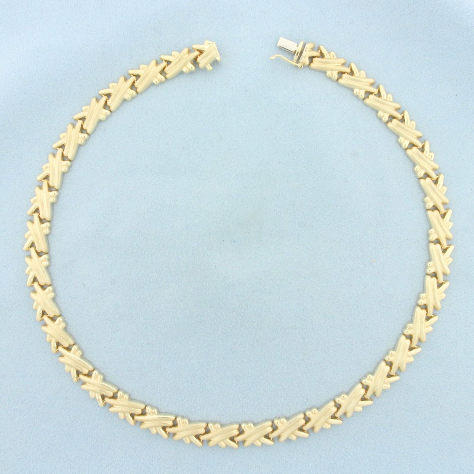 Italian 16 Inch Criss Cross Link Choker Necklace in 14k Yellow Gold: In 14k Yellow Gold. 16 inches long. 9mm wide. Italian made. Slide clasp with safety latch. 23.4g.