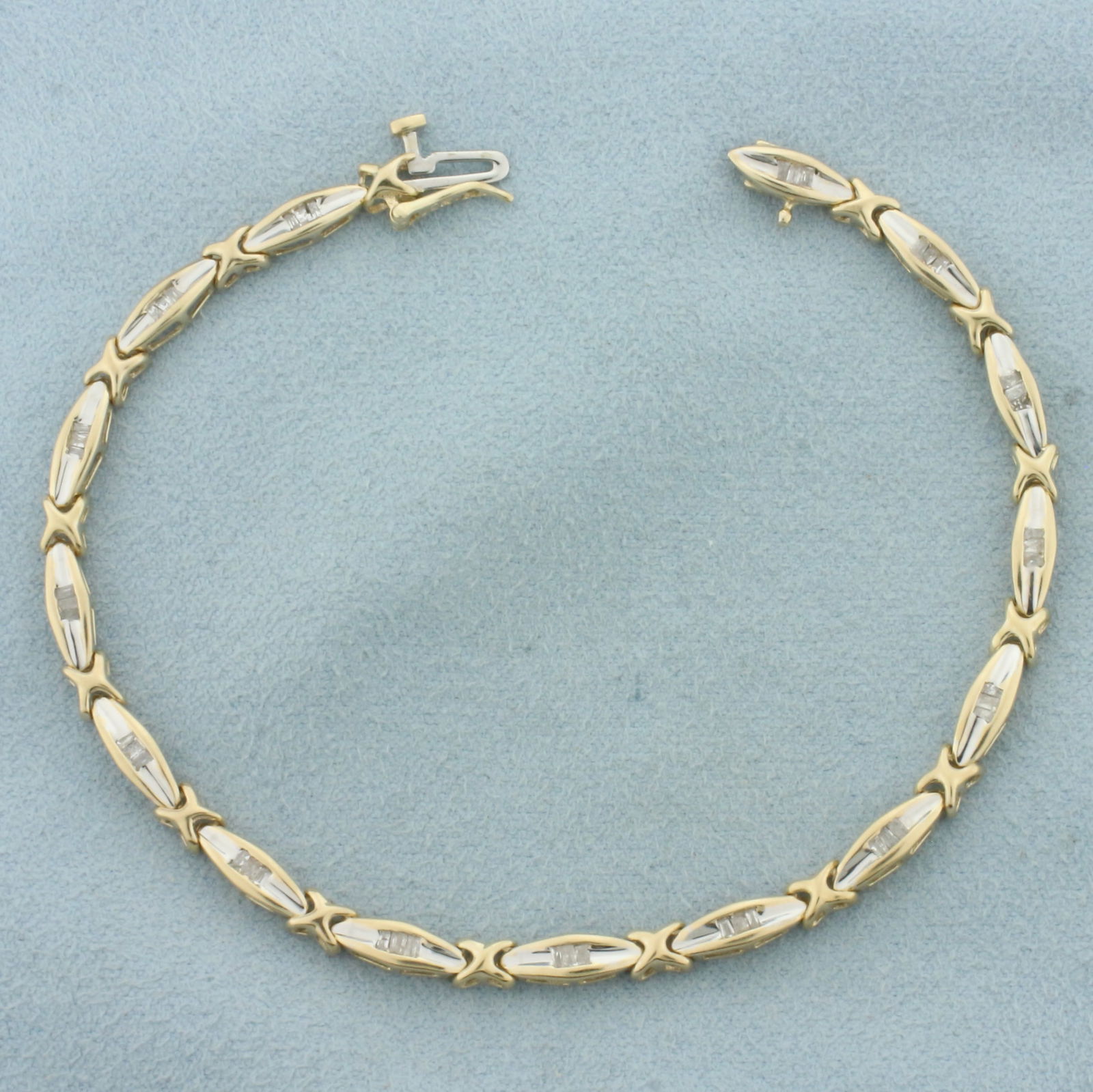 Baguette Diamond Tennis Bracelet in 10k Yellow Gold: In 10k Yellow Gold. Contains forty-five high quality baguette diamonds, 1/2ct TW, I color/I clarity. 7 3/8 inches long. 1/8 inch wide. Concealed slide clasp with safety latch. 7.0g.