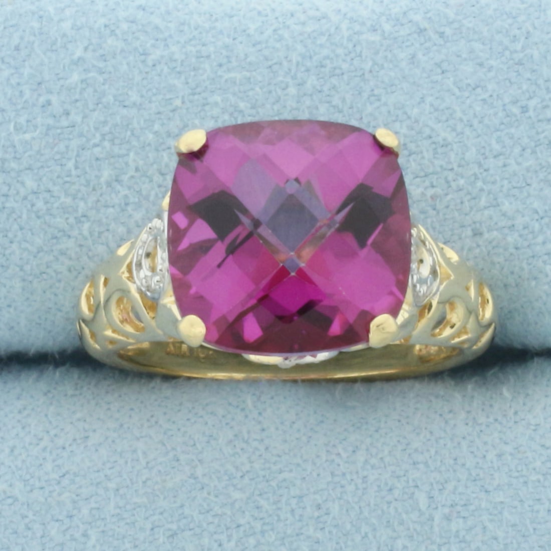 Pink Topaz and Diamond Ring in 10k Yellow Gold: In 10k Yellow Gold. Contains one 12x12mm high quality fancy cushion checkerboard cut natural Pink Topaz gemstone with intense color and excellent clarity. Also contains eight high quality 1/2pt diamon