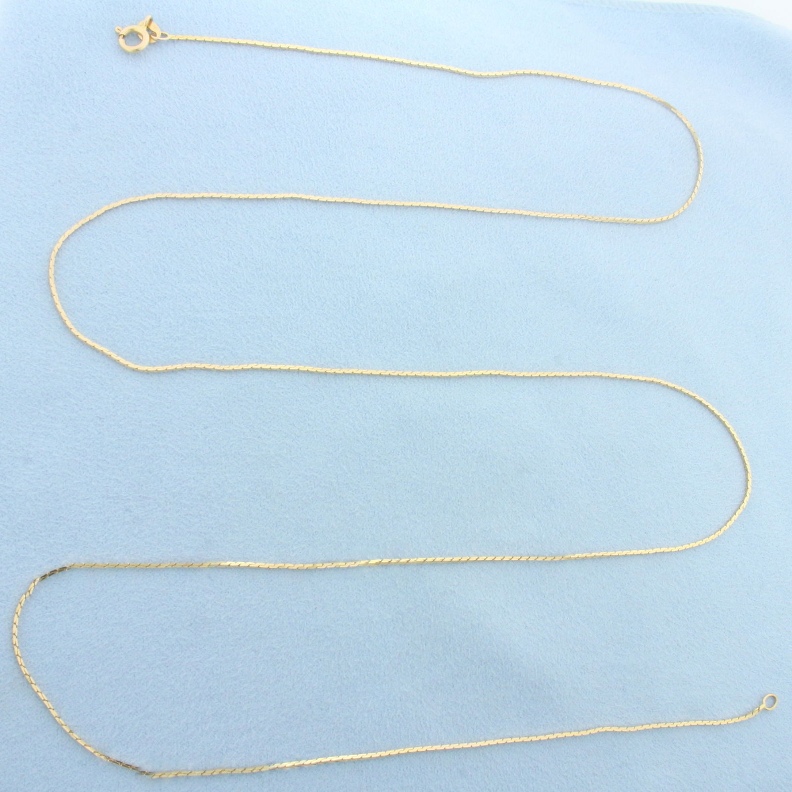 30 Inch Cobra Link Chain Necklace in 14k Yellow Gold: In 14k Yellow Gold. 30 inches long. 1.0mm wide. Spring clasp. 4.6g.