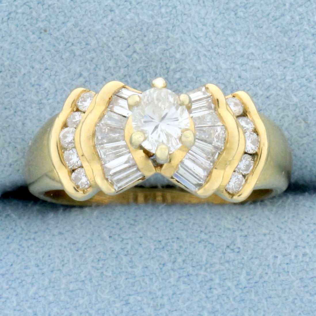 Oval Baguette and Round Diamond Engagement Ring in 14K Yellow Gold: In 14K Yellow Gold. Contains one 1/2ct oval, ten .01ct round , and fourteen .02ct baguette high quality diamonds, all VS clarity/G color, great cut for added brilliance. 1ct TW of diamonds. Size 7 3/4