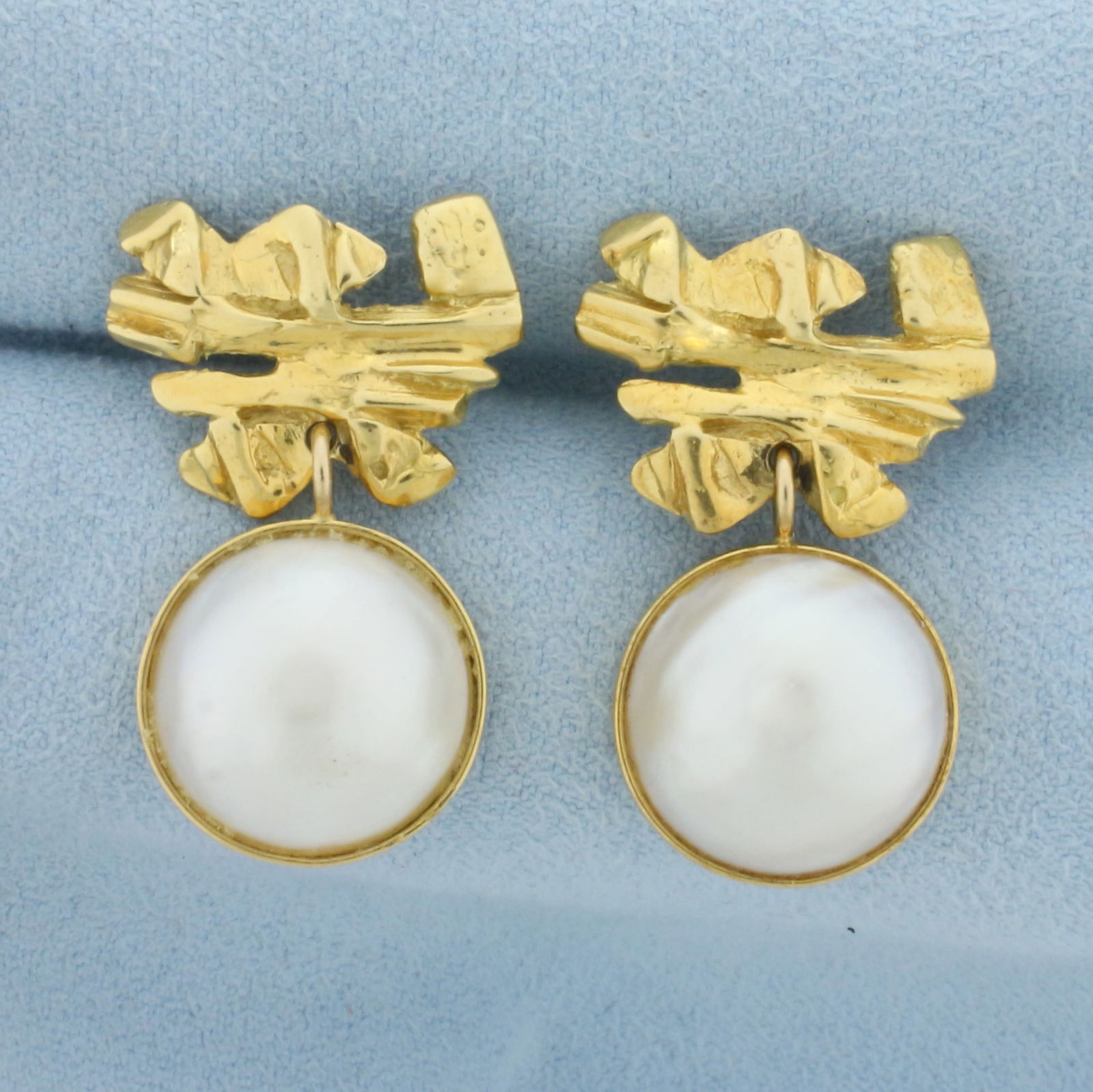 Designer Dangle Mabe Pearl Dangle Earrings in 18K Yellow Gold: In 18K Yellow Gold. Each earring contains one high quality 13.6mm Mabe Pearl with beautiful iridescent undertones. 1 1/8 inches long, 3/4 inch wide. Friction backs. 10.7g.