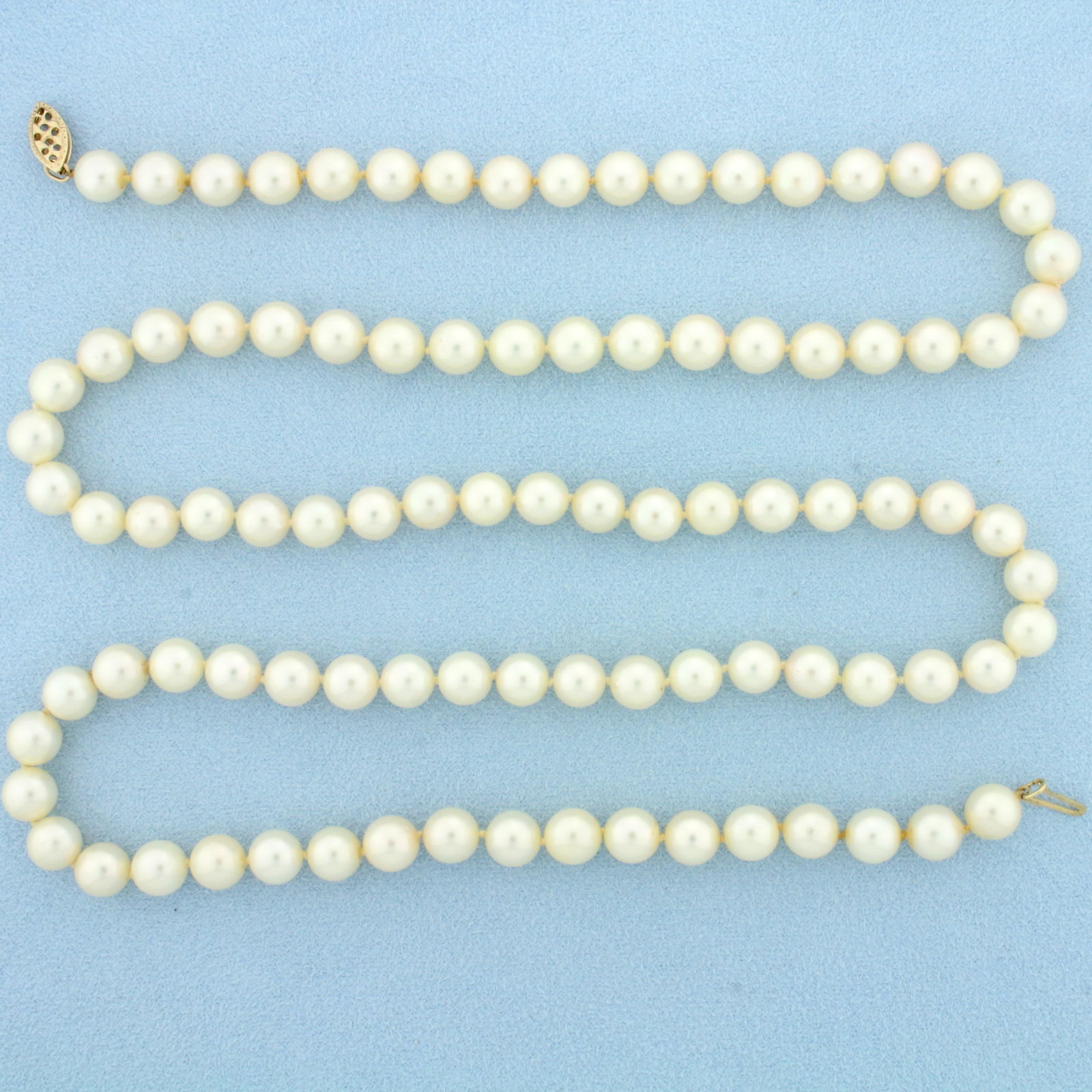 29 Inch Akoya Pearl Strand Necklace in 14K Yellow Gold: 14K Yellow Gold clasp. 29 inches long. Contains ninety three very high quality 7mm cultured Akoya Pearls, creamy pink undertone, beautiful nacre. 50.8g.