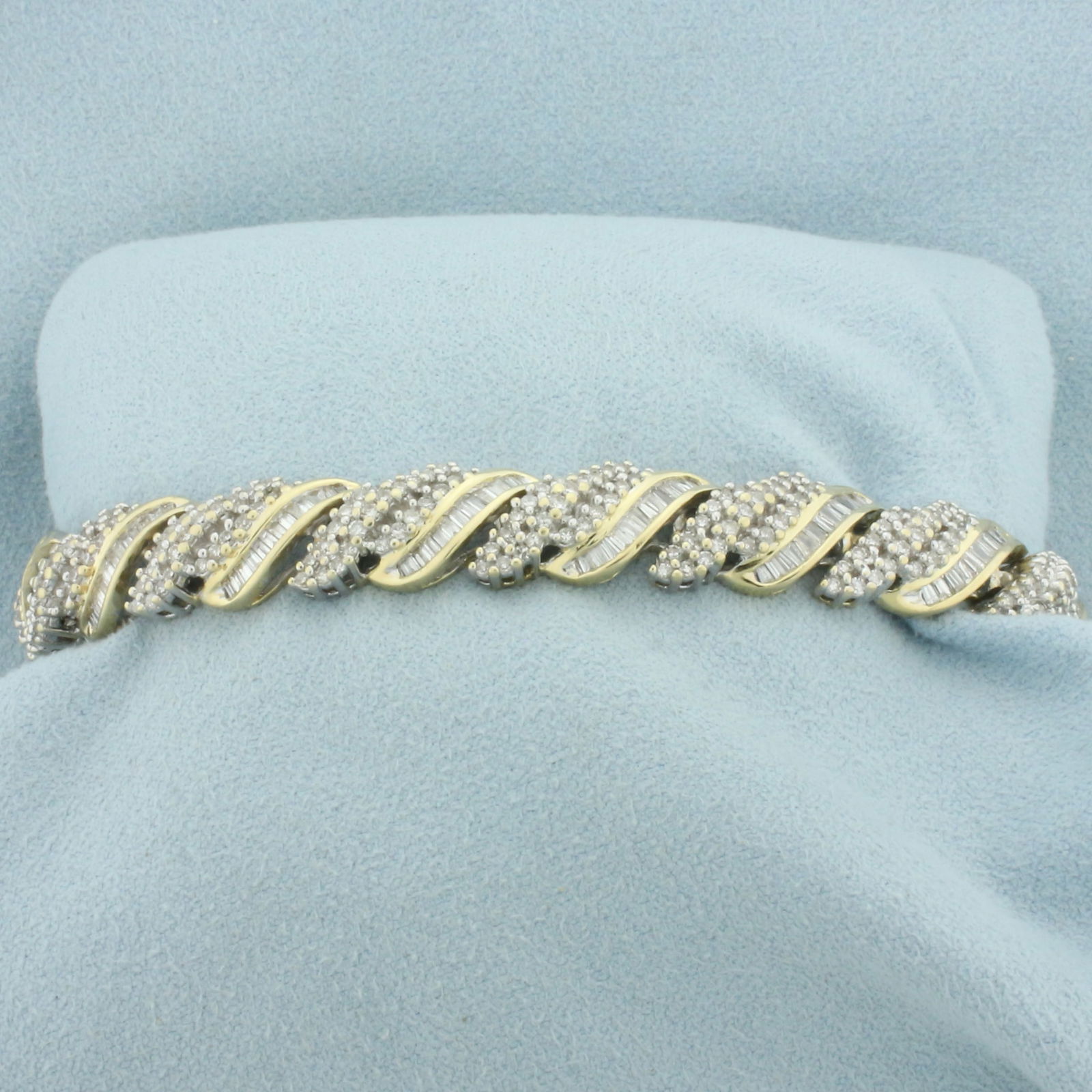 5ct Round and Baguette Diamond Bracelet in 14k Yellow Gold: In 14k yellow gold. Contains 312 round and 169 baguette high quality diamonds, 5ct TW, SI clarity/H color. 6 1/2 inches long and 10mm wide. Concealed slide in clasp with safety chain. 23.9g.