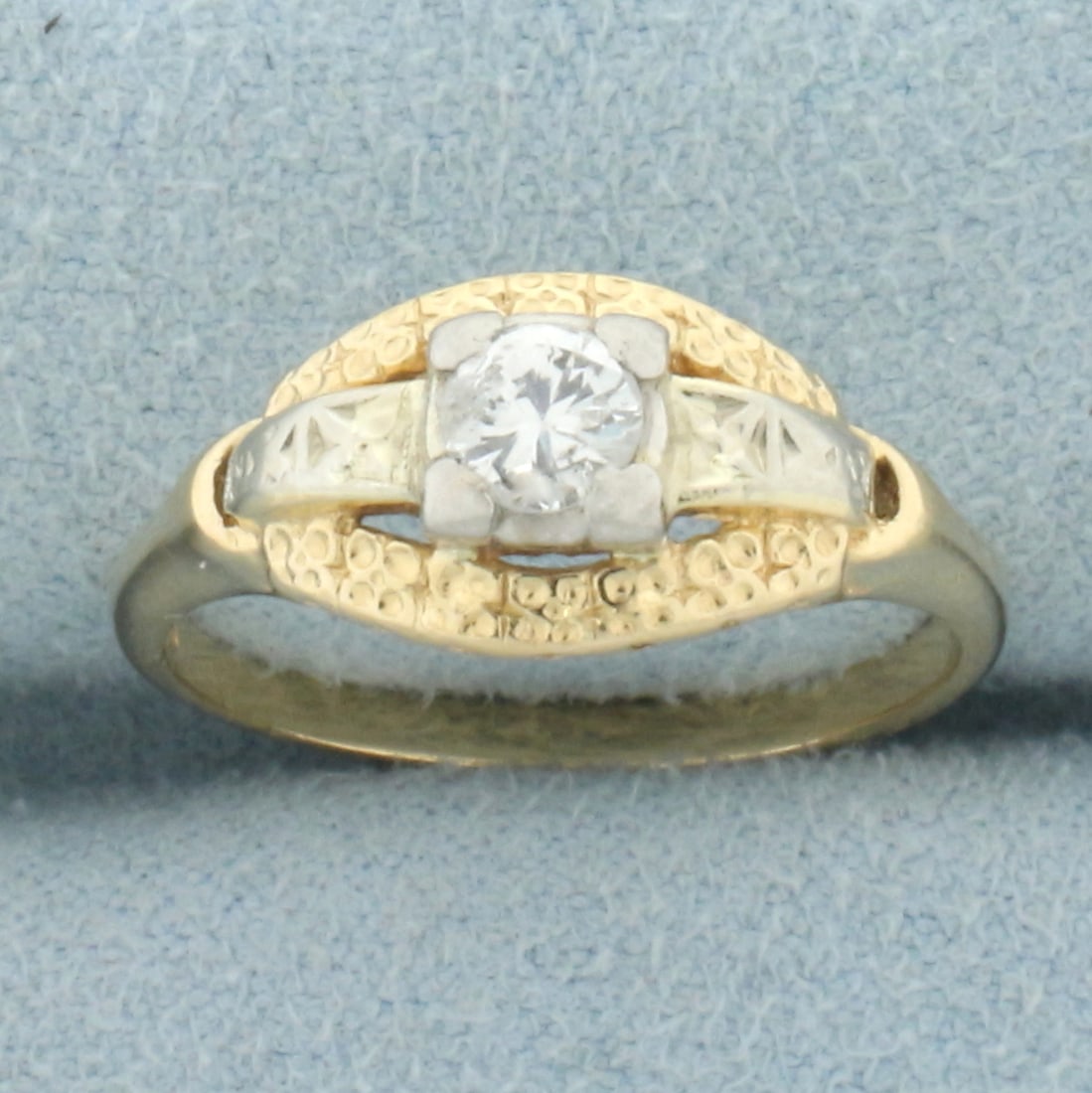 Vintage Diamond Ring in 14k Yellow and White Gold: In 14k yellow and white gold. Contains one high quality 1/4ct round brilliant diamond, H color/I clarity. 8.3mm wide at center. Size: 6.5.