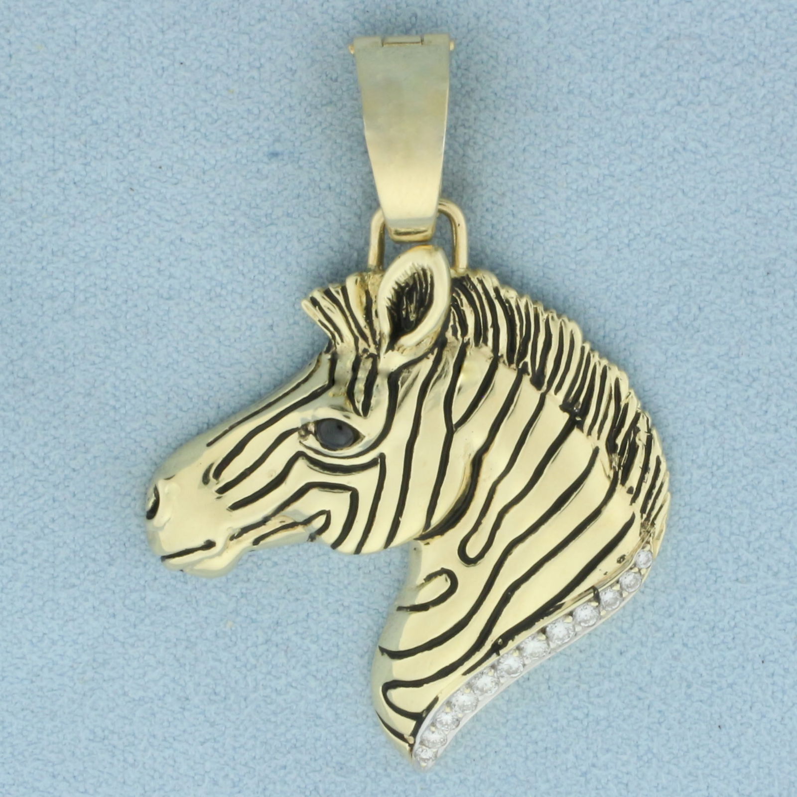 Diamond and Sapphire Zebra Pendant in 14k Yellow Gold: In 14k yellow gold. Contains twelve high quality diamonds, 1/5ct TW, VS clarity/F color. Also contains one high quality 2.25mm Sapphire gemstone as an eye. Hinged locking bale with safety latch for ea