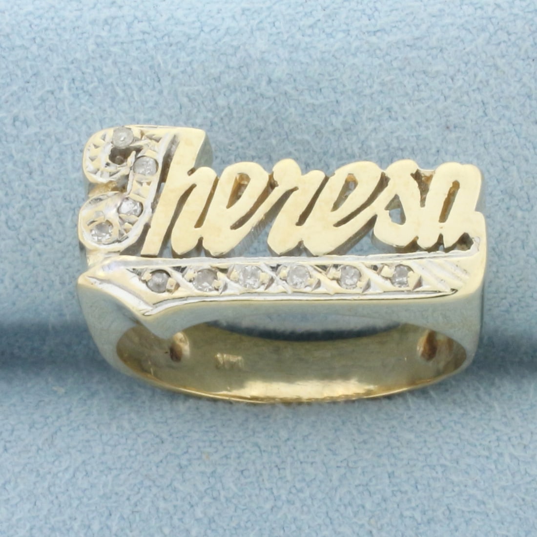Diamond Theresa Name Ring in 14k Yellow Gold: In 14k yellow gold. Contains nine high quality .01ct diamonds,SI clarity/H color. 11mm wide at widest part. Size: 8.5. 5.8g.