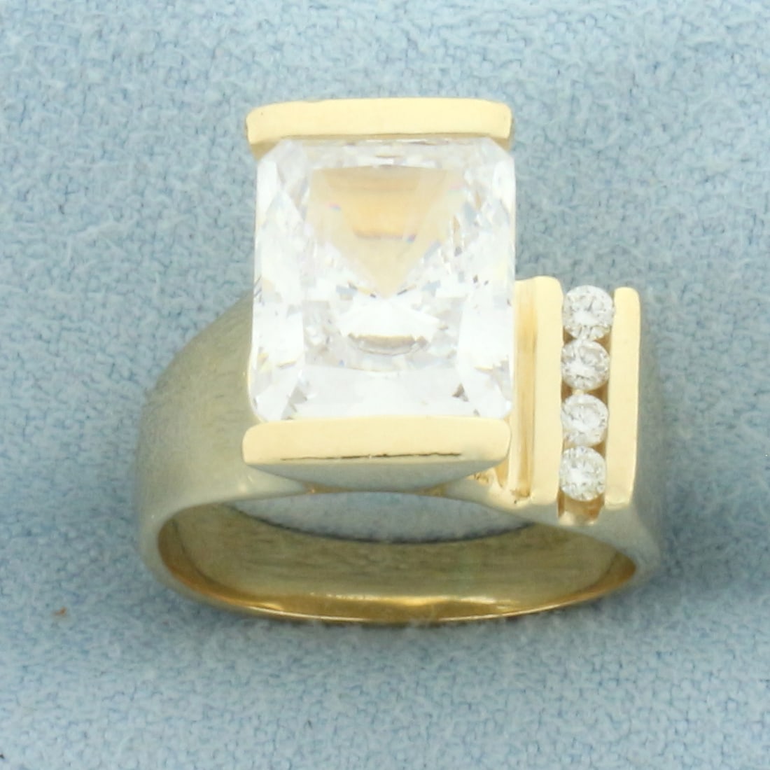 Radiant CZ and Diamond Ring in 14k Yellow Gold: In 14k yellow gold. Contains one high quality 8mm by 10m, radiant cut rectangular CZ gemstone with excellent cut and clarity for added sparkle. Also contains four high quality .01ct diamonds, VS clari