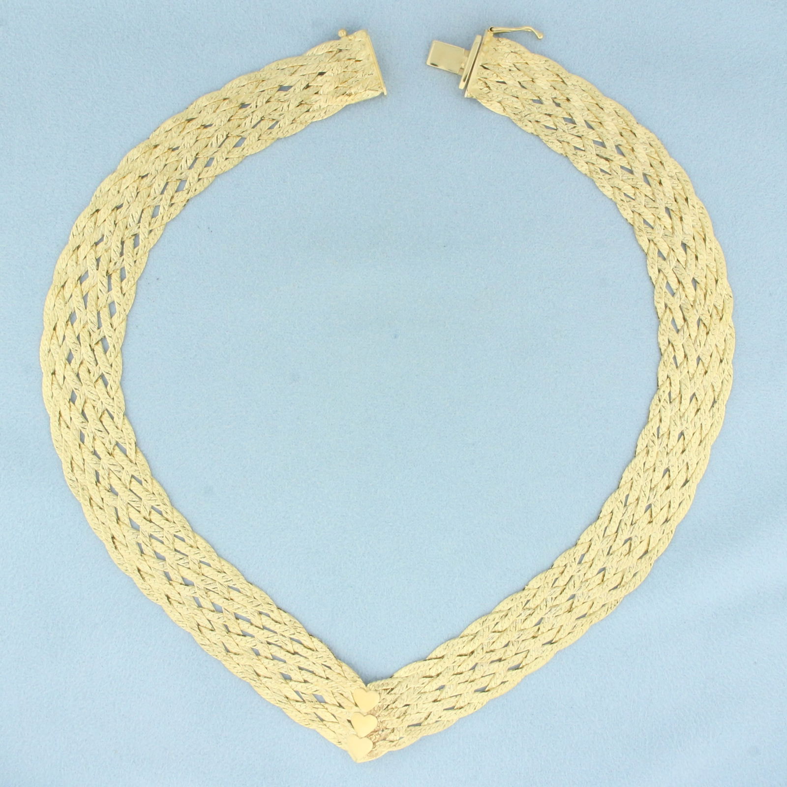 Italian Woven V-Neck Heart Necklace in 14k Yellow Gold: In 14k yellow gold. Italian made. 16 inches long and 5/8 inch wide. Unique diamond cut finish for extra sparkle. Slide clasp with safety latch. 32.5g.