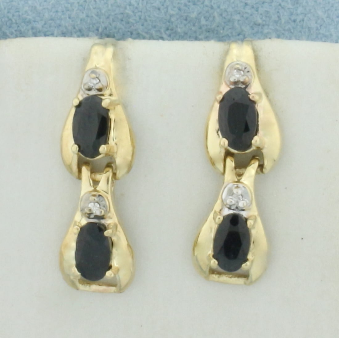 Sapphire and Diamond Dangle Earrings in 14k Yellow Gold: In 14k Yellow Gold. Contains four high quality natural 1/4ct Sapphire gemstones with deep color and excellent clarity. Also contains four high quality 1/2pt diamonds. 3/4 inch long. 1/4 inch wide. Fri