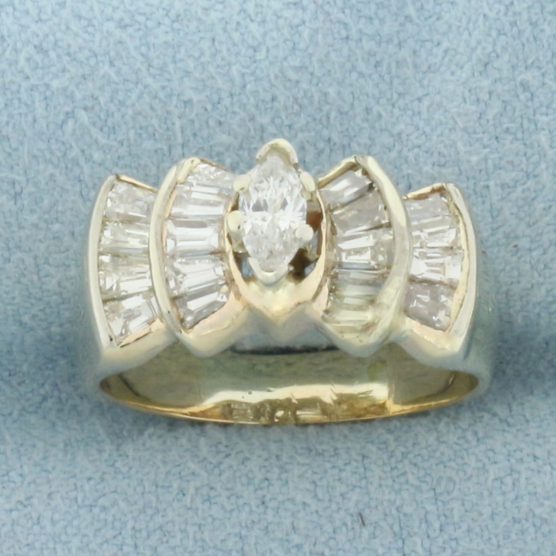 Vintage Marquise Diamond Engagement Ring in 14k Yellow Gold: In 14k Yellow Gold. Contains one 1/4ct high quality marquise diamond, SI clarity/H color. Also contains and eighteen high quality baguette diamonds, 1/4ct TW, of similar high quality. Size 6.5. 5.6g.