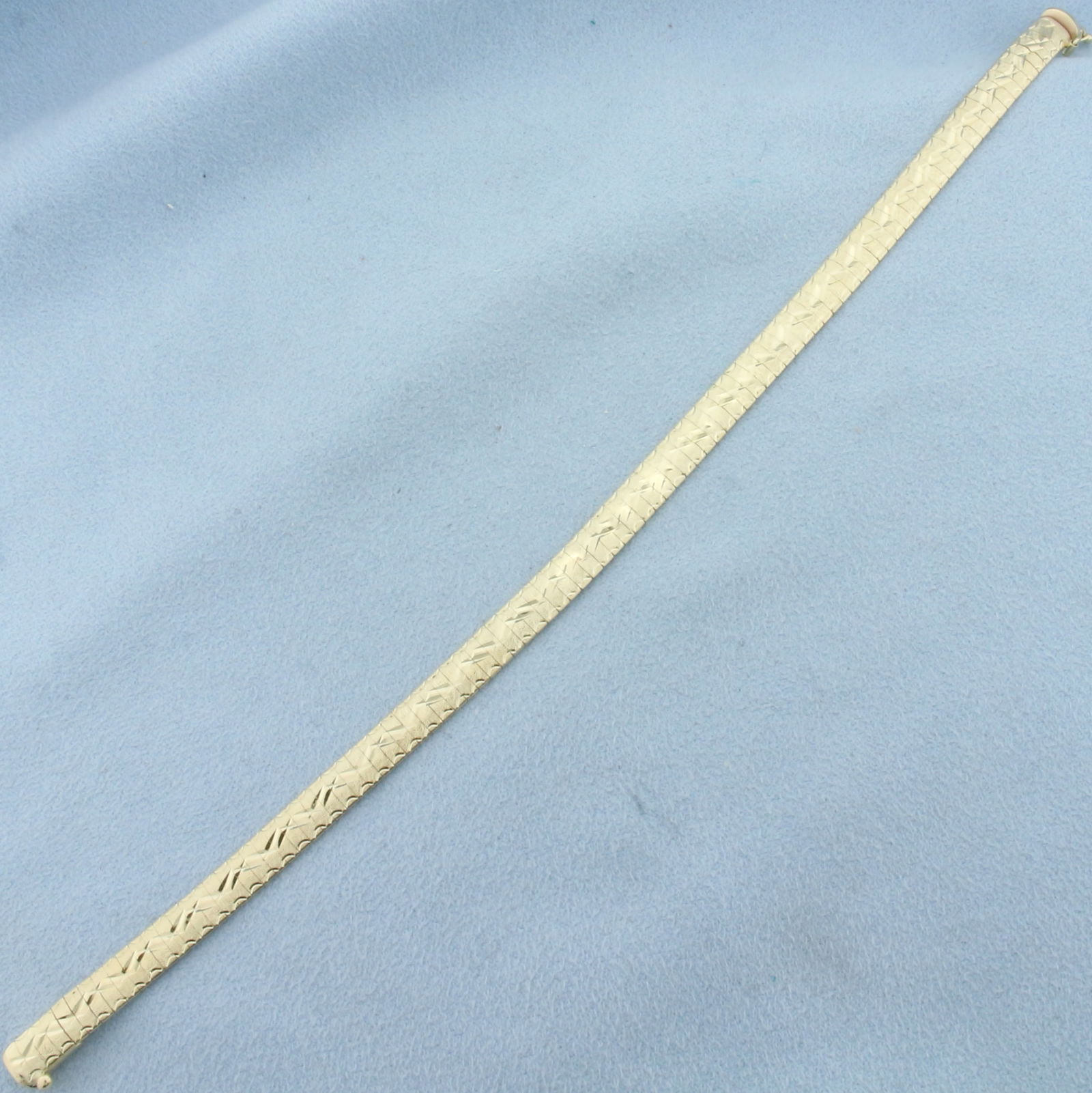 Italian Diamond Etched Omega Bracelet in 14k Yellow Gold: In 14k Yellow Gold. 7 7/8 inches long. 5.7mm wide. Italian made. Slide clasp with safety latch. 14.6g.