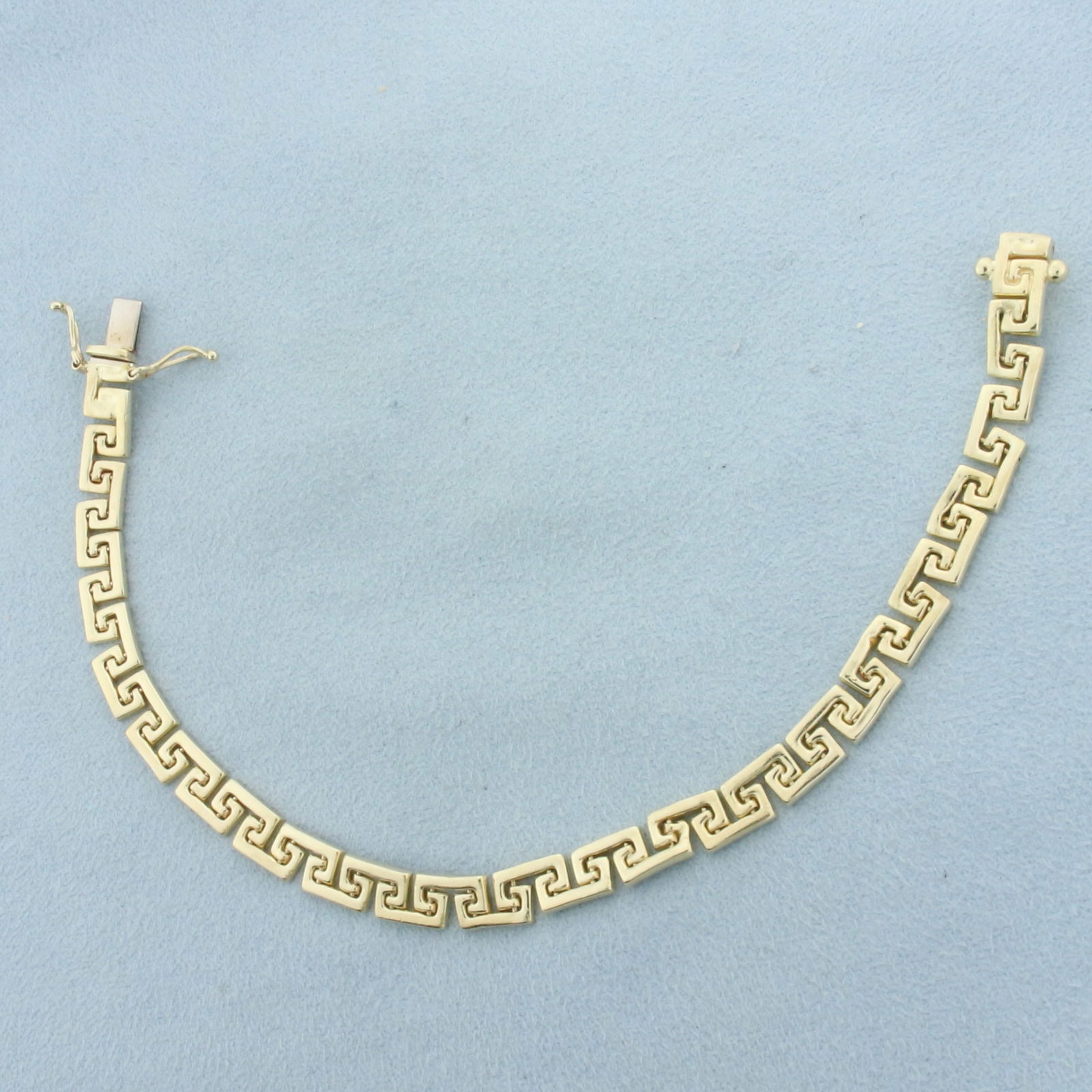 Italian Greek Key Bracelet in 14k Yellow Gold: In 14k Yellow Gold. 7 3/8 inches long. 5.7mm wide. Italian made. Concealed slide closure with safety latch. 10.5g.