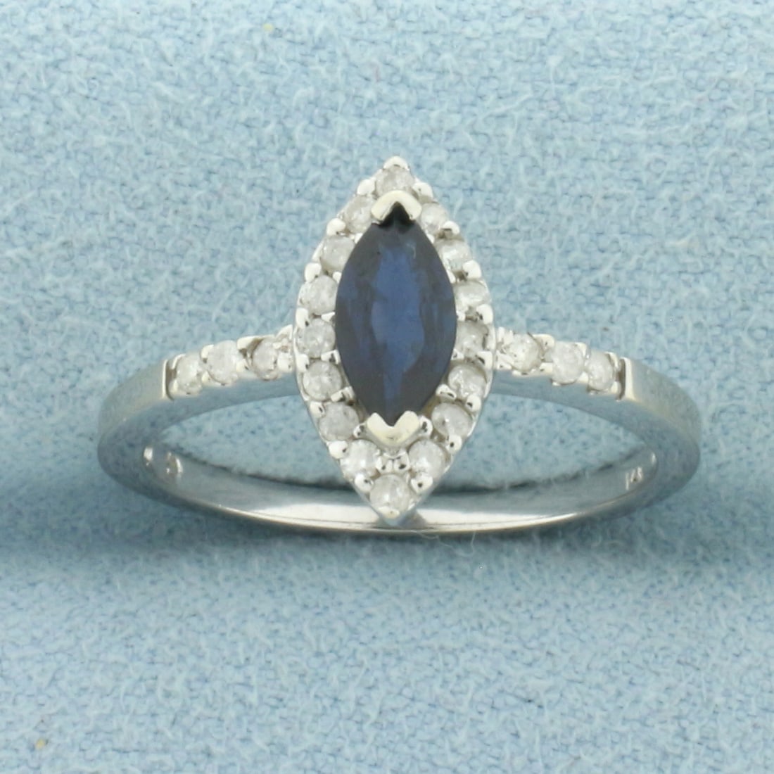 Sapphire and Diamond Halo Ring in 14k White Gold: In 14k White Gold. Contains one 8x4mm high quality marquise cut natural Sapphire gemstone, approximately .75ct, with intense color and excellent clarity. Also contains twenty-two high quality diamonds