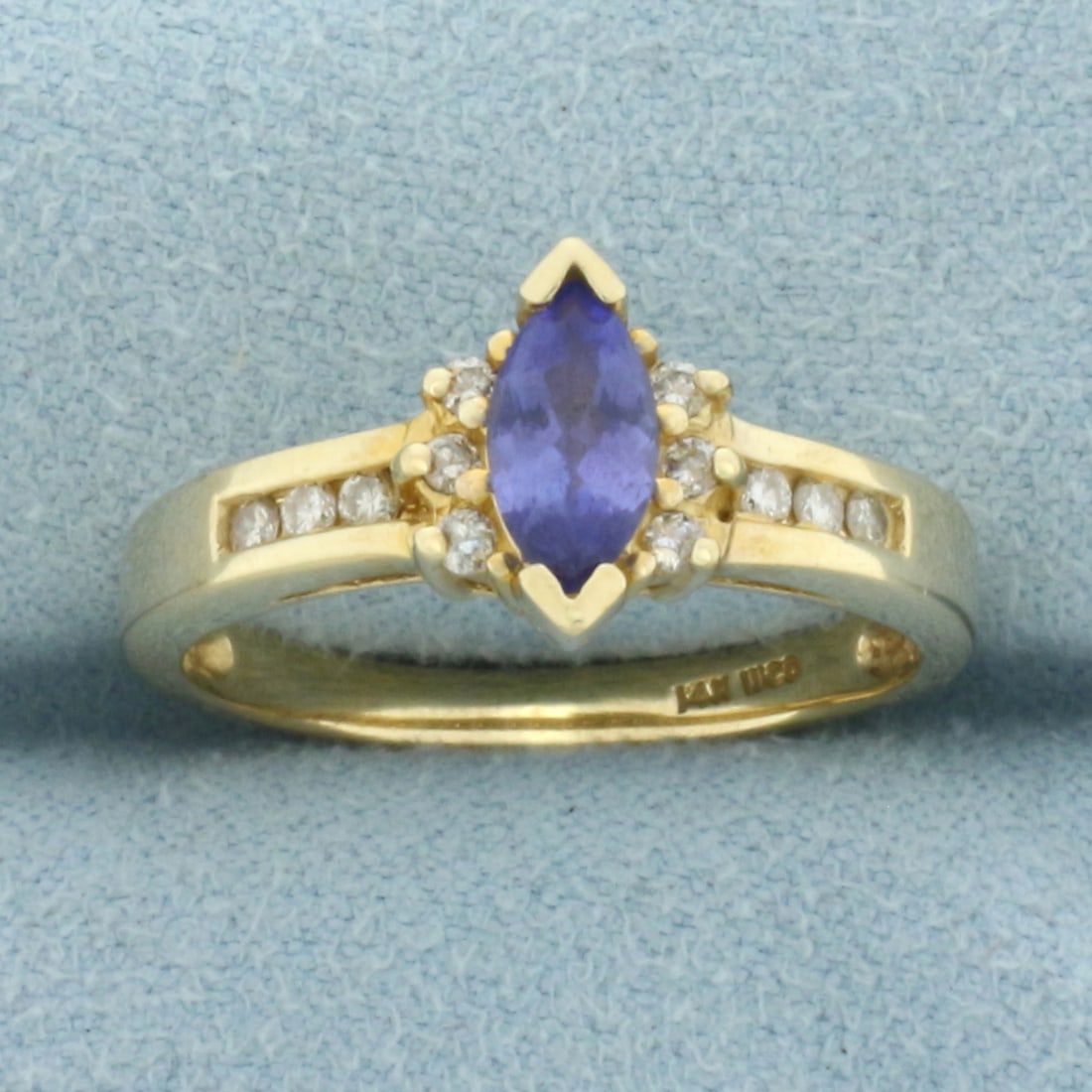 Tanzanite and Diamond Ring in 14k Yellow Gold: In 14k Yellow Gold. Contains one 4x8mm high quality marquise cut natural Tanzanite gemstone, approximately 3/4ct, with vibrant color and excellent clarity. Also contains twelve .01ct TW high quality d