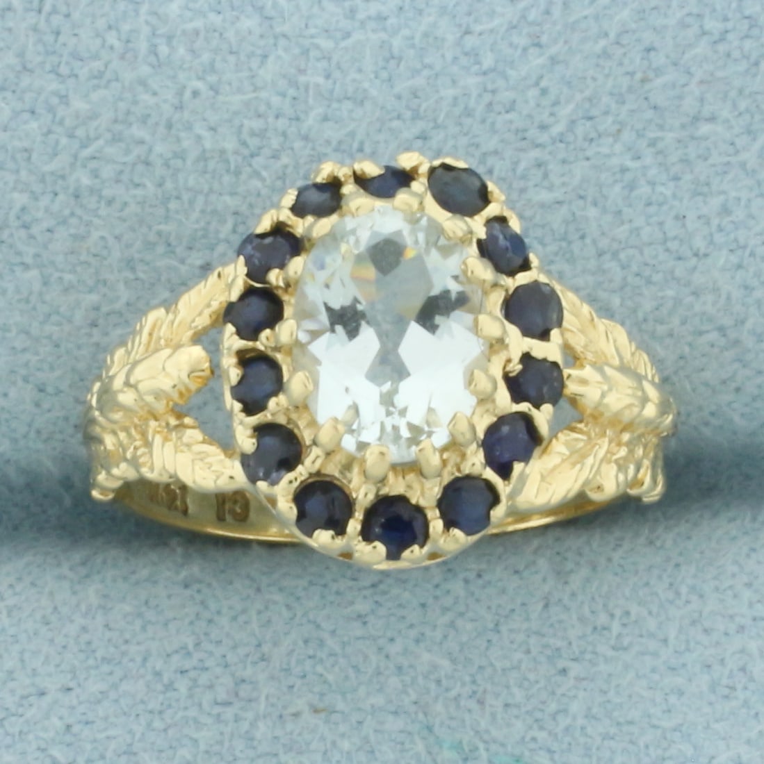 Aquamarine and Sapphire Halo Ring in 14k Yellow Gold: In 14k Yellow Gold. Contains one 8x6mm high quality natural Aquamarine gemstone, approximately 1ct, with bright color and excellent clarity. Also contains fourteen 2mm high quality natural Sapphire ge