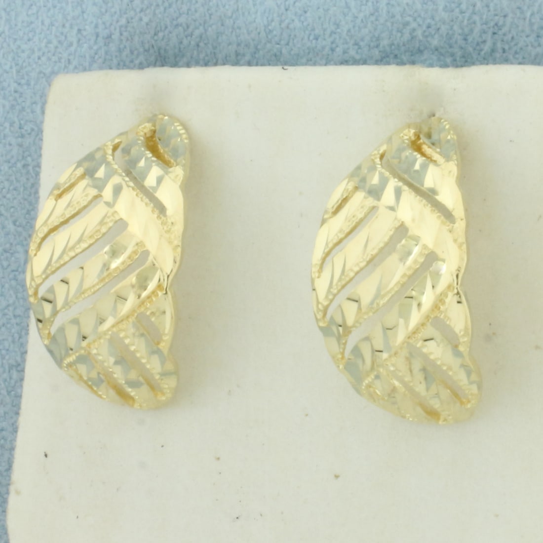 Diamond Cut Half Hoop Earrings in 14k Yellow Gold: In 14k Yellow Gold. 3/4 inch long. 3/8 inch wide. Friction backs. 2.7g,