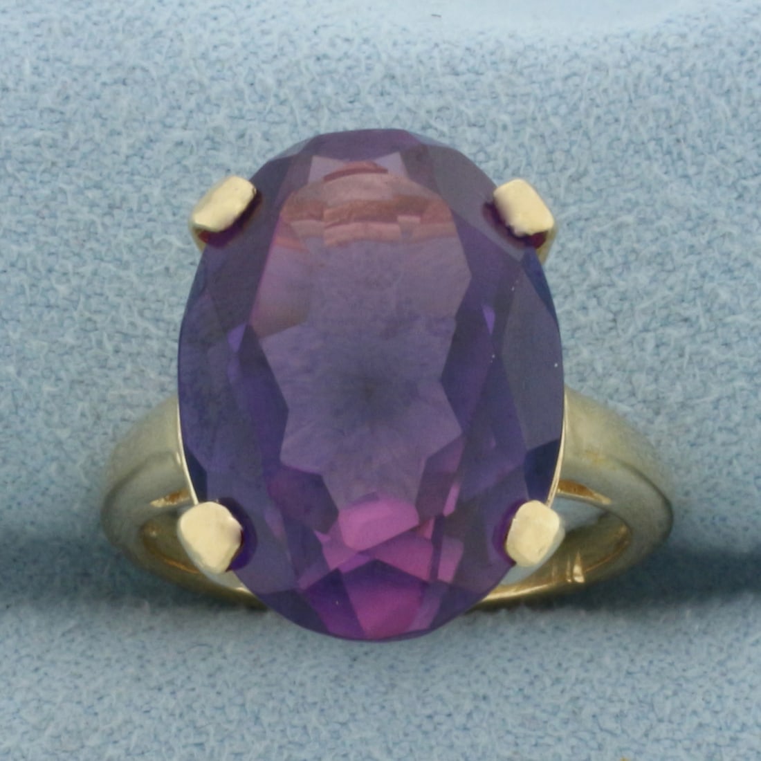 Color Changing Lab Sapphire Ring in 14k Yellow Gold: In 14k Yellow Gold. Contains one 18x13mm high quality oval cut Lab Sapphire gemstone, approximately 13cts, with color shift from purple to pink. Size 6.25. 8.3g