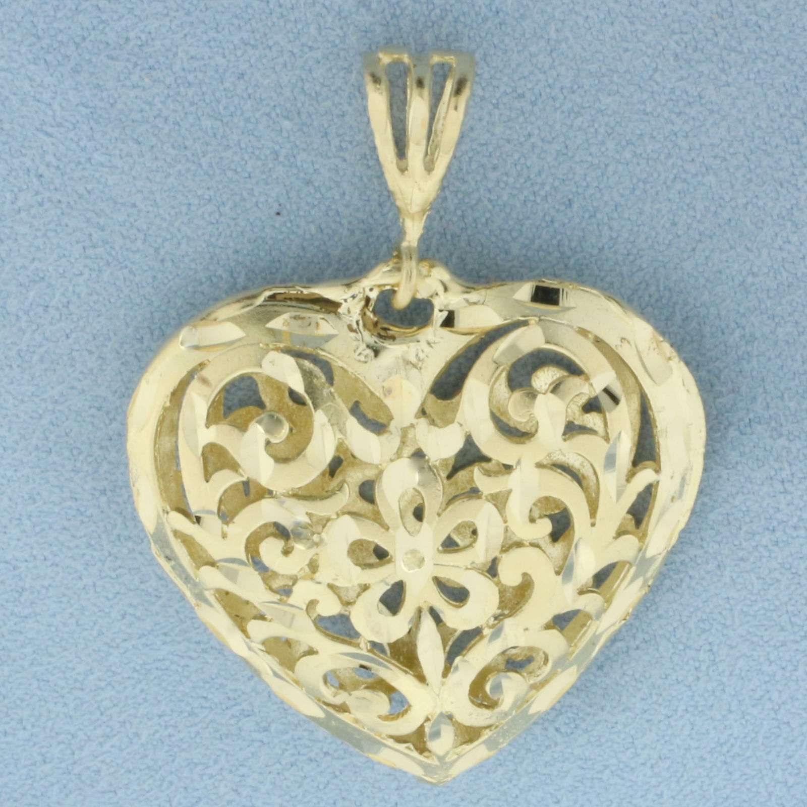 Diamond Cut Filigree Cutout 3D Heart Pendant in 14k Yellow Gold: In14_k Yellow Gold. 1 3/4 inch long (including bale). 1 1/4 inch wide. 8.2g.