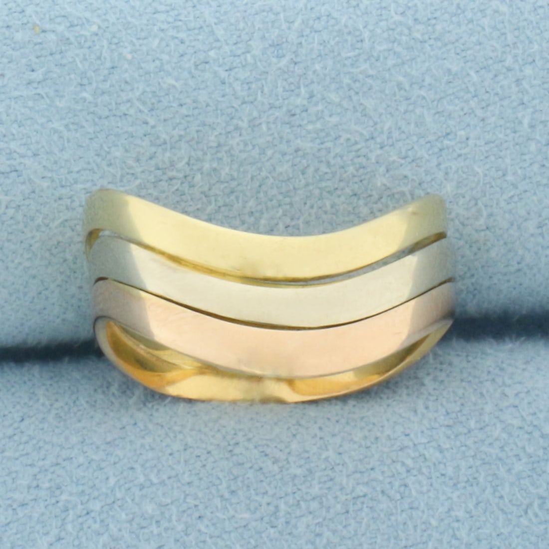 Tri-Color Wave Design Ring Stack in 18k Yellow, White, and Rose Gold: In 18k Yellow, White, and Rose Gold. 7.3mm wide. 3 rings are soldered together. Size 7. 3.7g.