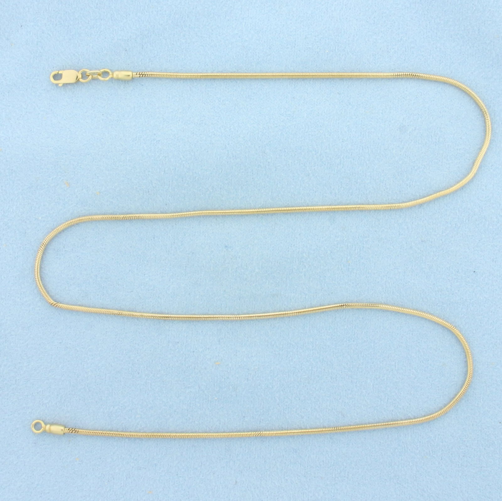 19 Inch Italian Snake Link Chain Necklace in 14k Yellow Gold: In 14k Yellow Gold. 19 inches long. 1.4mm wide. Italian made. Lobster clasp. 8.4g.