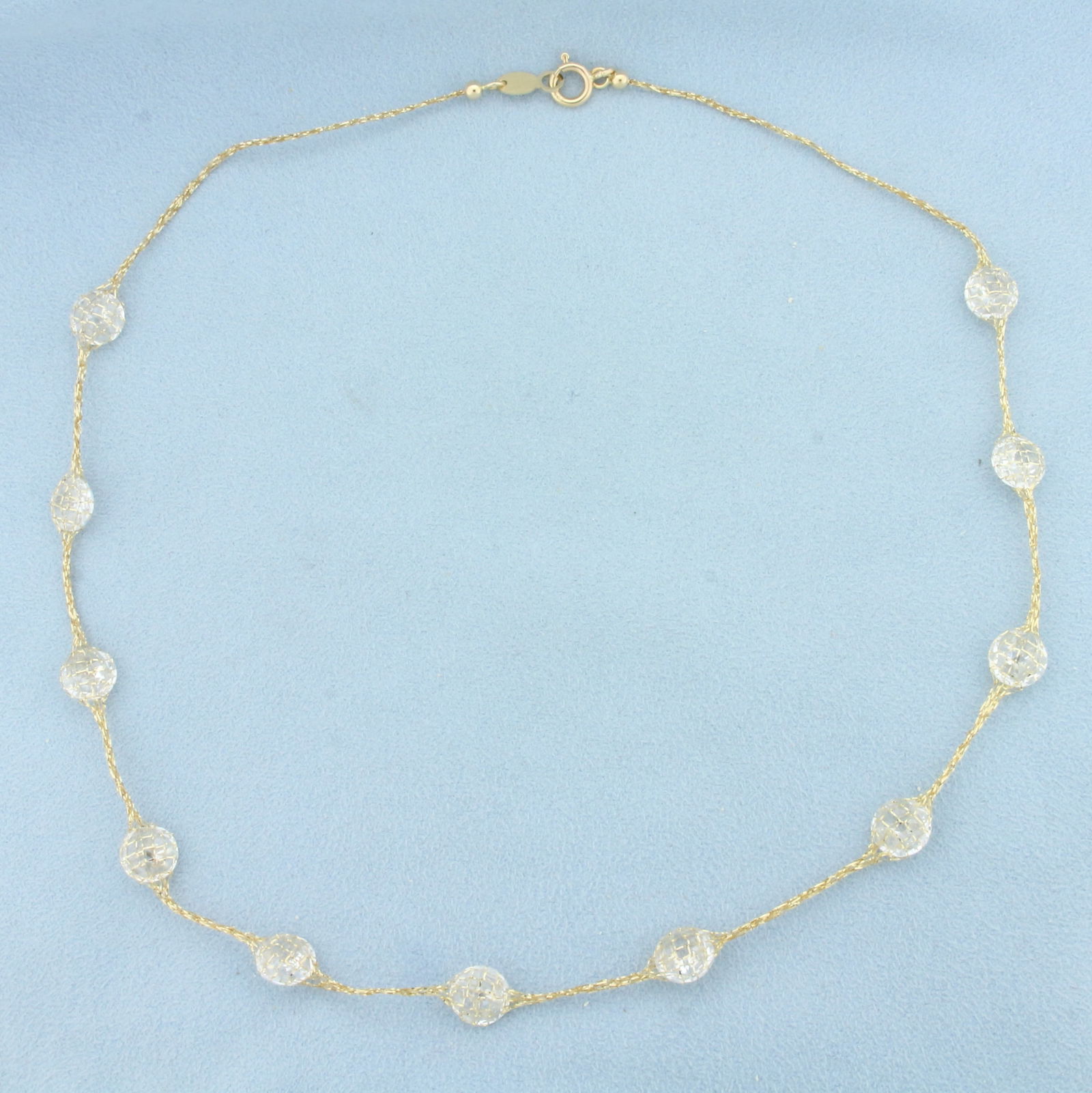 Italian CZ Disco Ball Station Necklace in 14k Yellow Gold: In 14k yellow gold. Italian Made. Contains eleven 1/3 inch CZ gemstones. 18 inches long. 1mm thick chain. 8.7g.