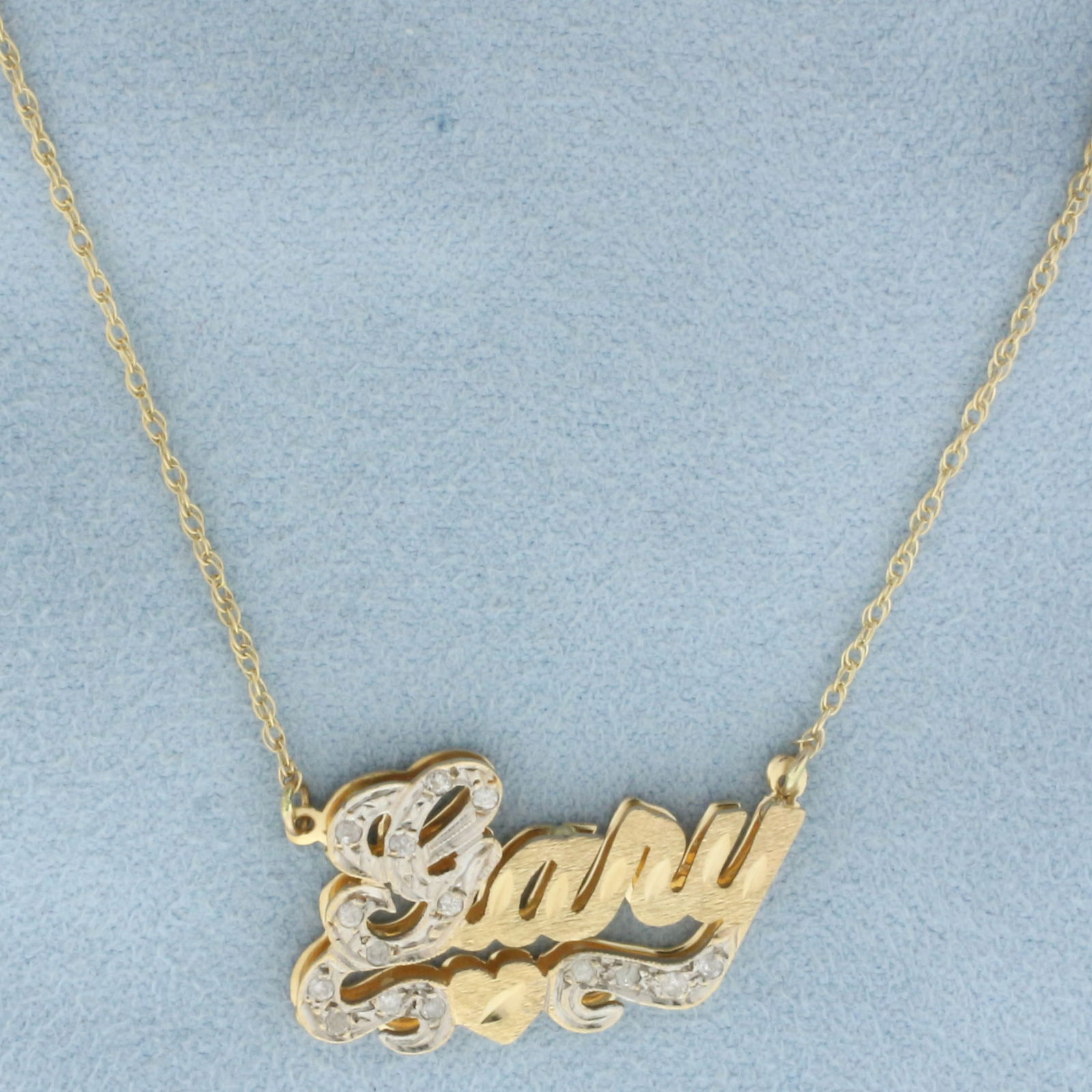 Diamond "Gary" Necklace in 14k Yellow Gold: In 14k yellow gold. Contains fifteen high quality 1/2pt diamonds. 19 inch long and 1.1 inch wide chain, spring clasp. Nameplate is 1 inch by 5/8 inch. 3.9g.