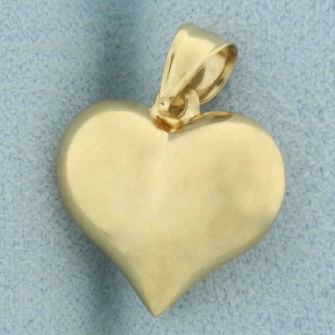 3-D Heart Pendant or Charm in 14k Yellow Gold: In 14k Yellow Gold. 5/8 inch long. 1/2 inch wide. 1.2g.
