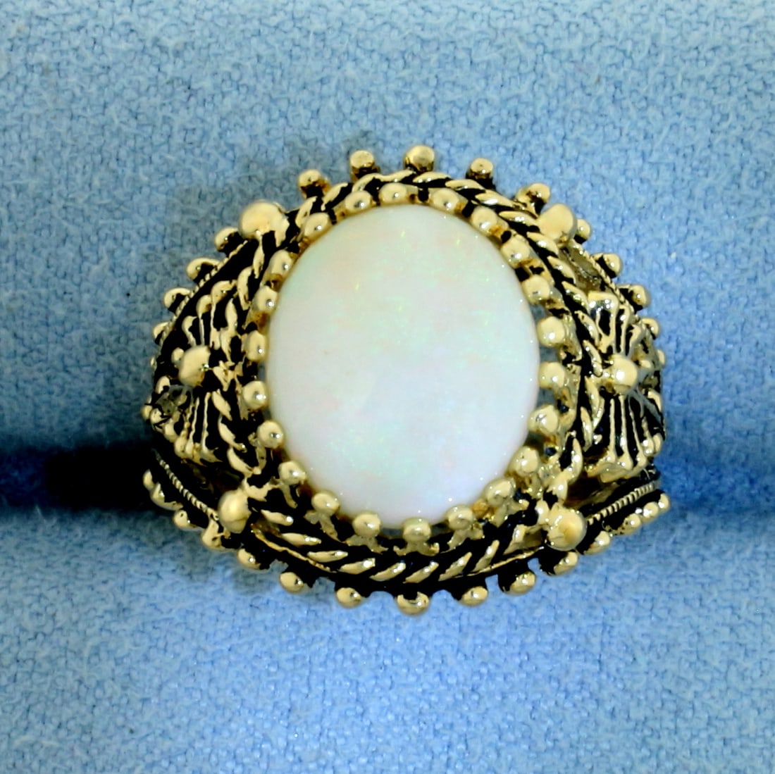 Vintage Opal Ring in 14k Yellow Gold: In 14k Yellow Gold. Contains one high quality 12mmx10mm natural Opal gemstone with flashes of yellow, orange, blue, and green. 17.3mm wide at top. Size 6. 5.2g.